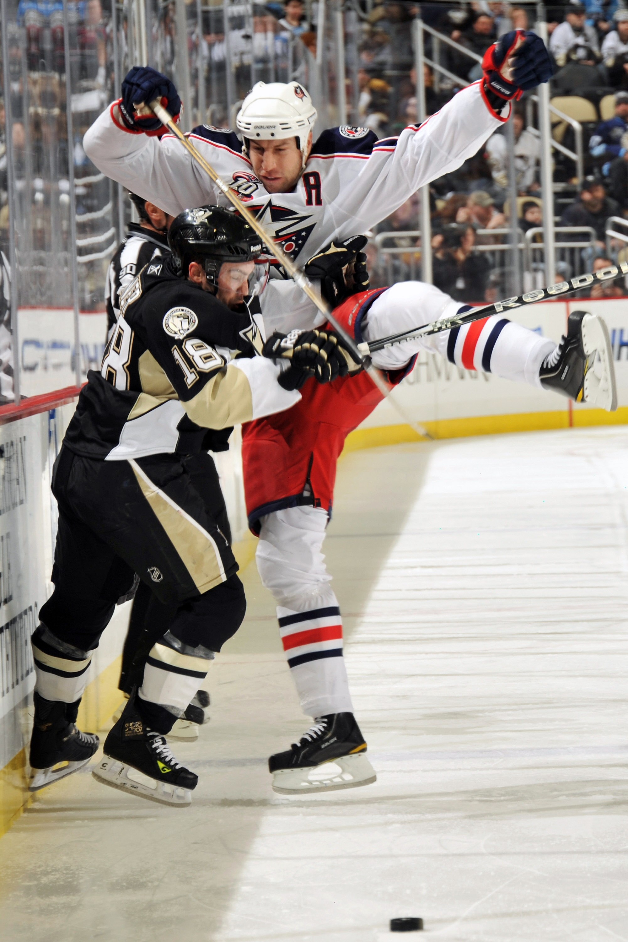 PITTSBURGH, PA - FEBRUARY 8:  Chris Conner #18 of the Pittsburgh Penguins knocks R.J. Umberger #18 of the Columbus Blue Jackets off the puck in the second period on February 8, 2011 at CONSOL Energy Center in Pittsburgh, Pennsylvania.  (Photo by Jamie Sab