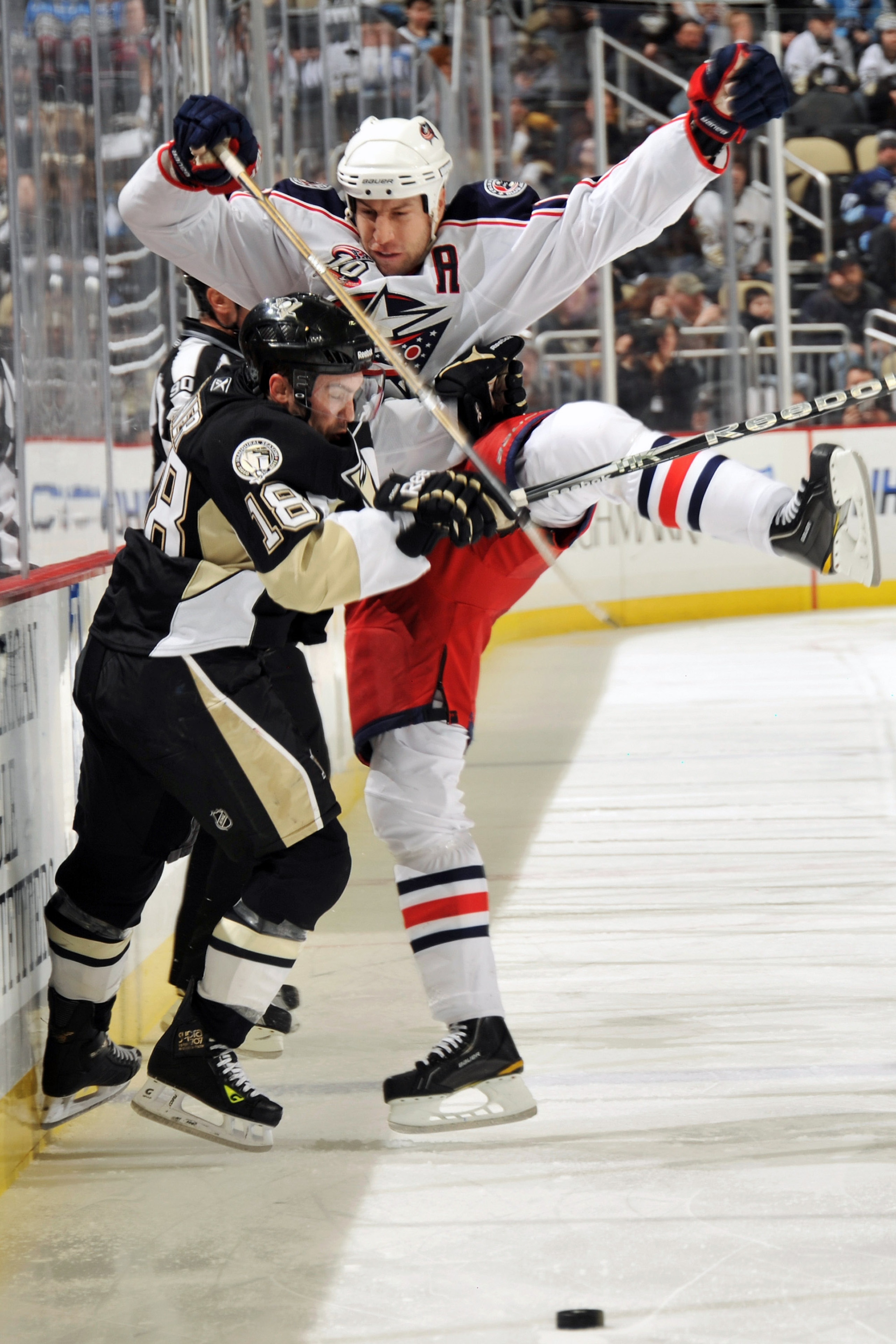 PITTSBURGH, PA - FEBRUARY 8:  Chris Conner #18 of the Pittsburgh Penguins knocks R.J. Umberger #18 of the Columbus Blue Jackets off the puck in the second period on February 8, 2011 at CONSOL Energy Center in Pittsburgh, Pennsylvania.  (Photo by Jamie Sab