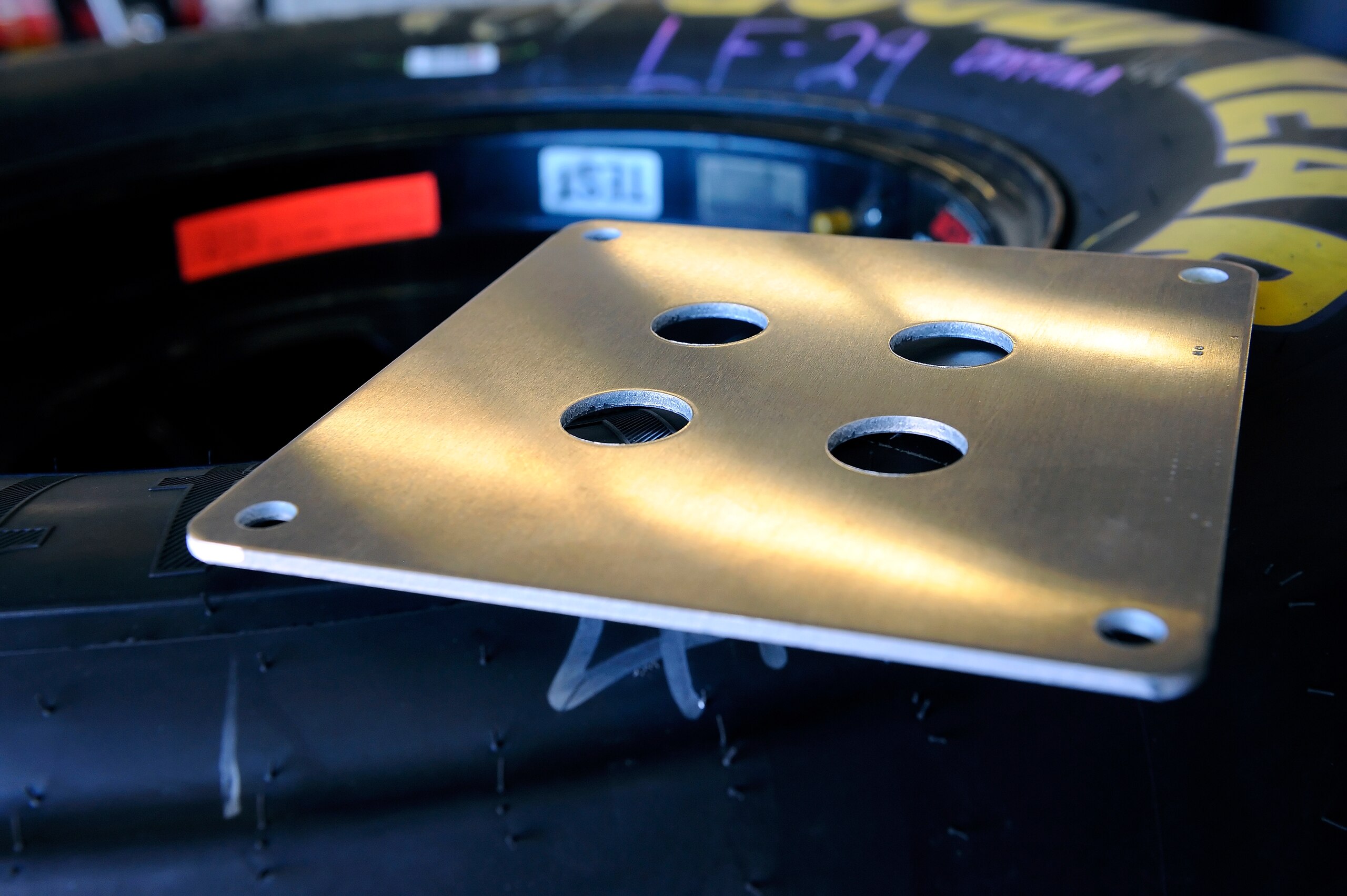 DAYTONA BEACH, FL - JANUARY 22:  The 29/32'' restrictor plate sits atop a set of Goodyear tires in the garage during testing at Daytona International Speedway on January 22, 2011 in Daytona Beach, Florida.  (Photo by Jared C. Tilton/Getty Images for NASCA