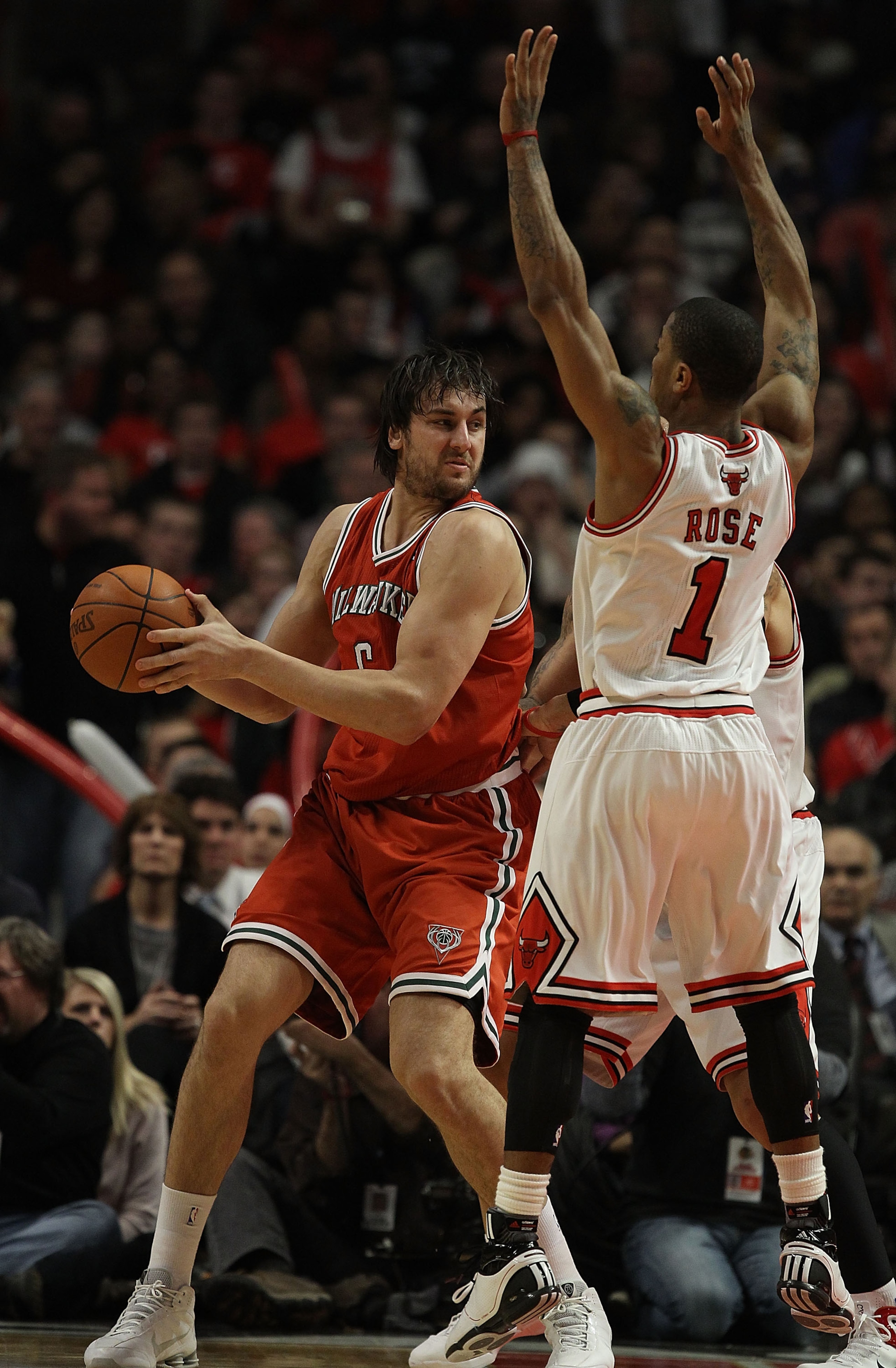 CHICAGO, IL - DECEMBER 28: Derrick Rose #1 of the Chicago Bulls leaps to block the view of Andrew Bogut #6 of the Milwaukee Bucks at the United Center on December 28, 2010 in Chicago, Illinois. The Bulls defeated the Bucks 90-77. NOTE TO USER: User expres CHICAGO, IL - DECEMBER 28: Derrick Rose #1 of the Chicago Bulls leaps to block the view of Andrew Bogut #6 of the Milwaukee Bucks at the United Center on December 28, 2010 in Chicago, Illinois. The Bulls defeated the Bucks 90-77. NOTE TO USER: User expres
