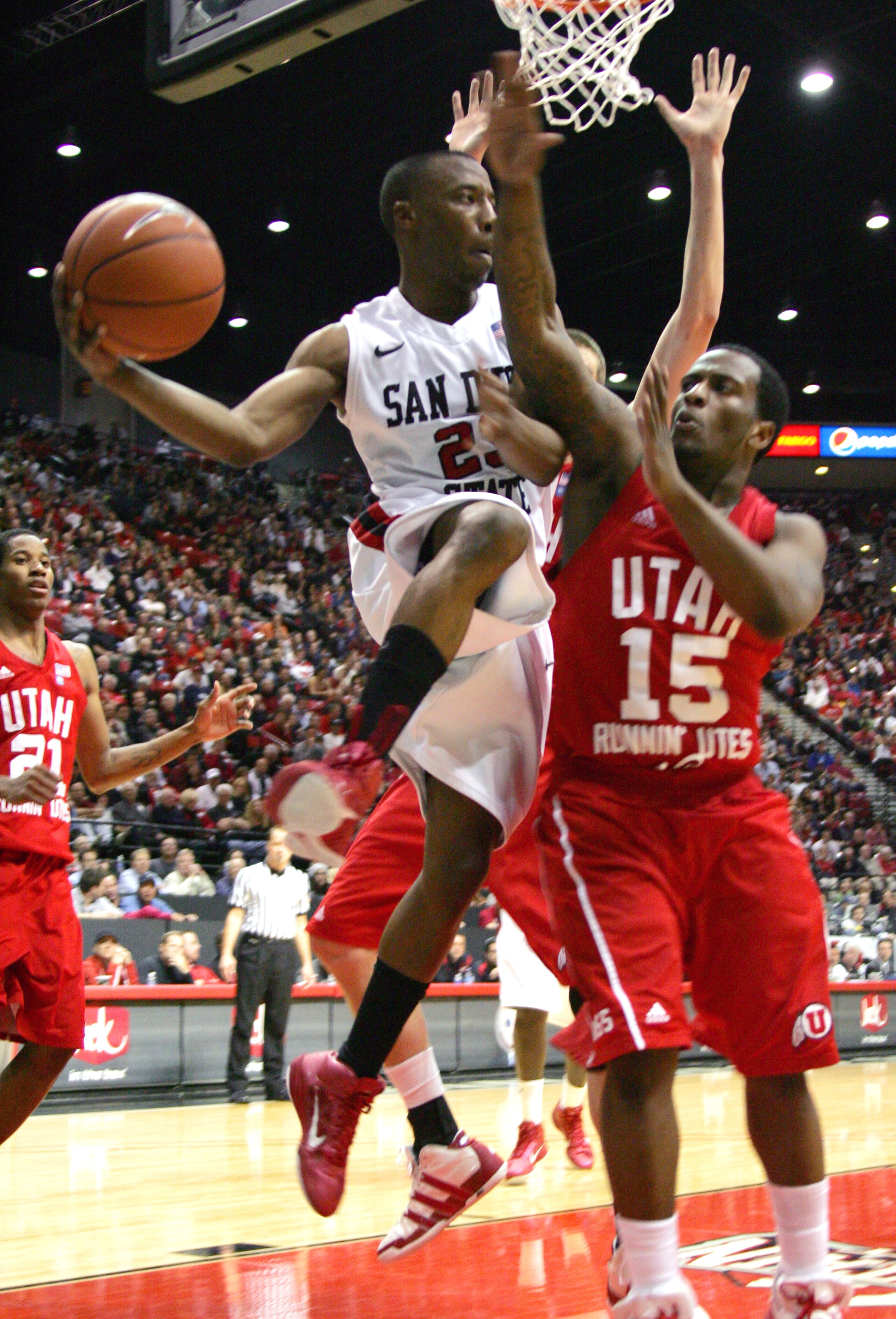 SAN DIEGO, CA - FEBRUARY 8: D.J. Gay #23 of San Diego State looks to pass the ball against Josh Watkins #15 of Utah on February 8, 2011 at Cox Arena in San Diego, California. SDSU beat Utah 85-58. (Photo by Kent Horner/Getty Images)