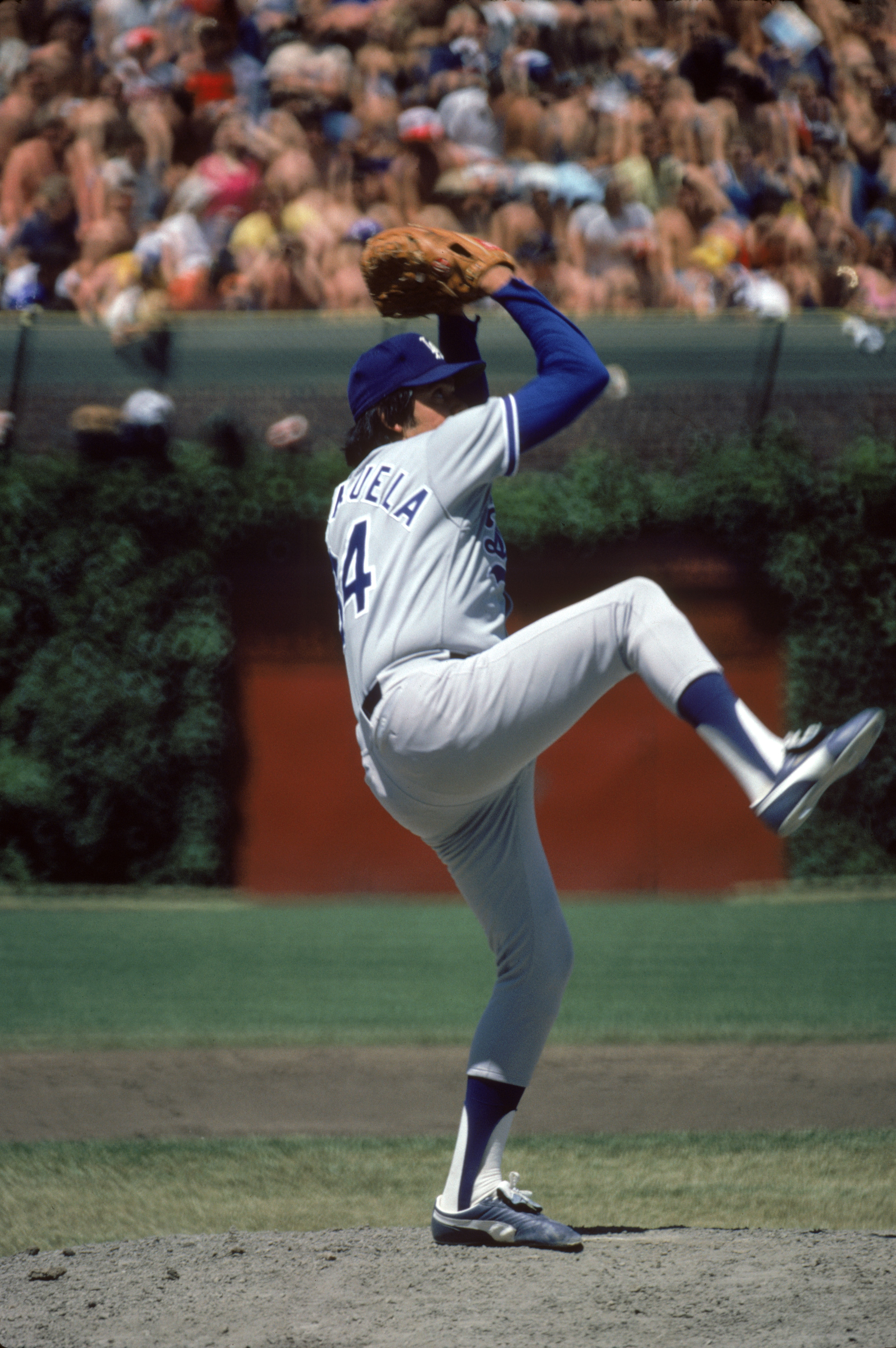 CHICAGO, IL - JUNE 6: Pitcher Fernando Valenzuela #34 of the Los Angeles Dodgers winds up for a pitch against the Chicago Cubs on June 6, 1981 at Wrigley Field in Chicago, Illinois. (Photo by: Jonathan Daniel/Getty Images)