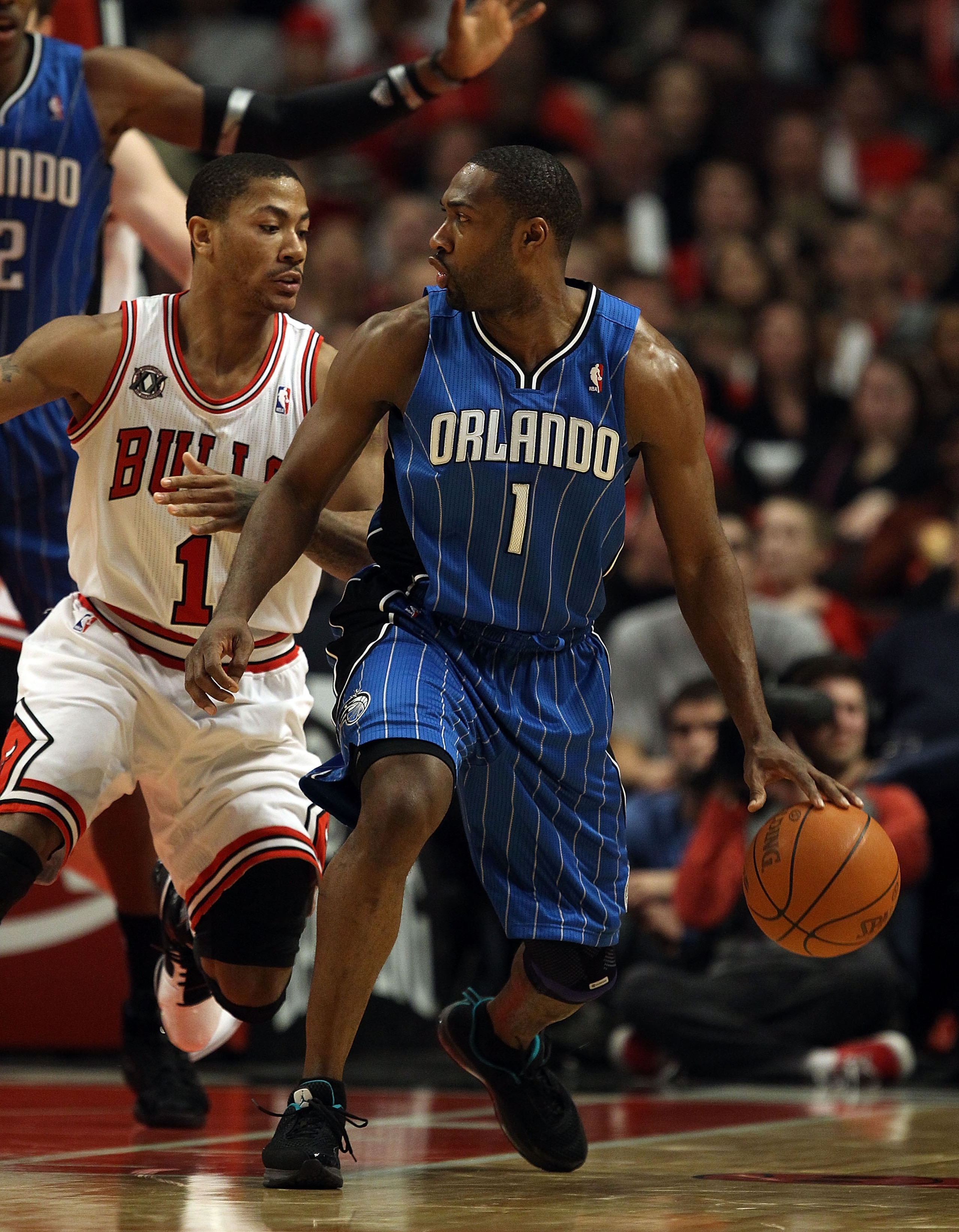 CHICAGO, IL - JANUARY 28: Gilbert Arenas #1 of the Orlando Magic moves against Derrick Rose #1 of the Chicago Bulls at the United Center on January 28, 2011 in Chicago, Illinois. The Bulls defeated the Magic 99-90. NOTE TO USER: User expressly acknowledge CHICAGO, IL - JANUARY 28: Gilbert Arenas #1 of the Orlando Magic moves against Derrick Rose #1 of the Chicago Bulls at the United Center on January 28, 2011 in Chicago, Illinois. The Bulls defeated the Magic 99-90. NOTE TO USER: User expressly acknowledge