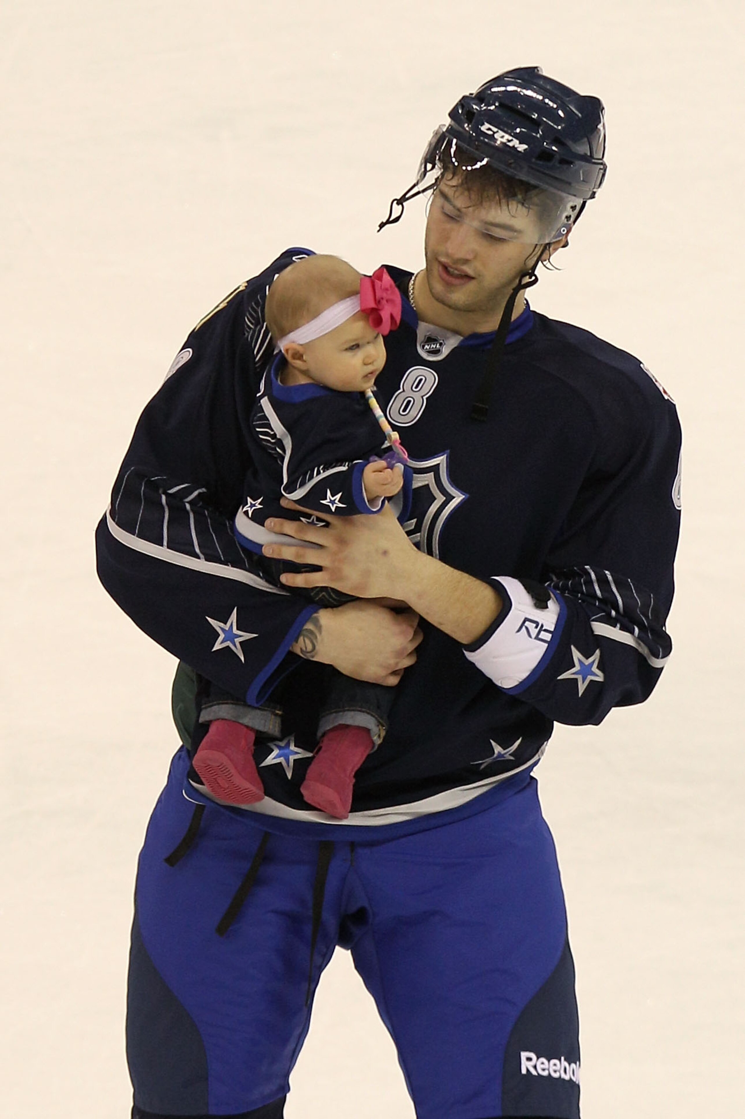 RALEIGH, NC - JANUARY 30:  Brent Burns #8 of the Minnesota Wild and Team Lidstrom holds his daughter Peyton after they defeated Team Staal 11 to 10 in the 58th NHL All-Star Game at RBC Center on January 30, 2011 in Raleigh, North Carolina.  (Photo by Bruc