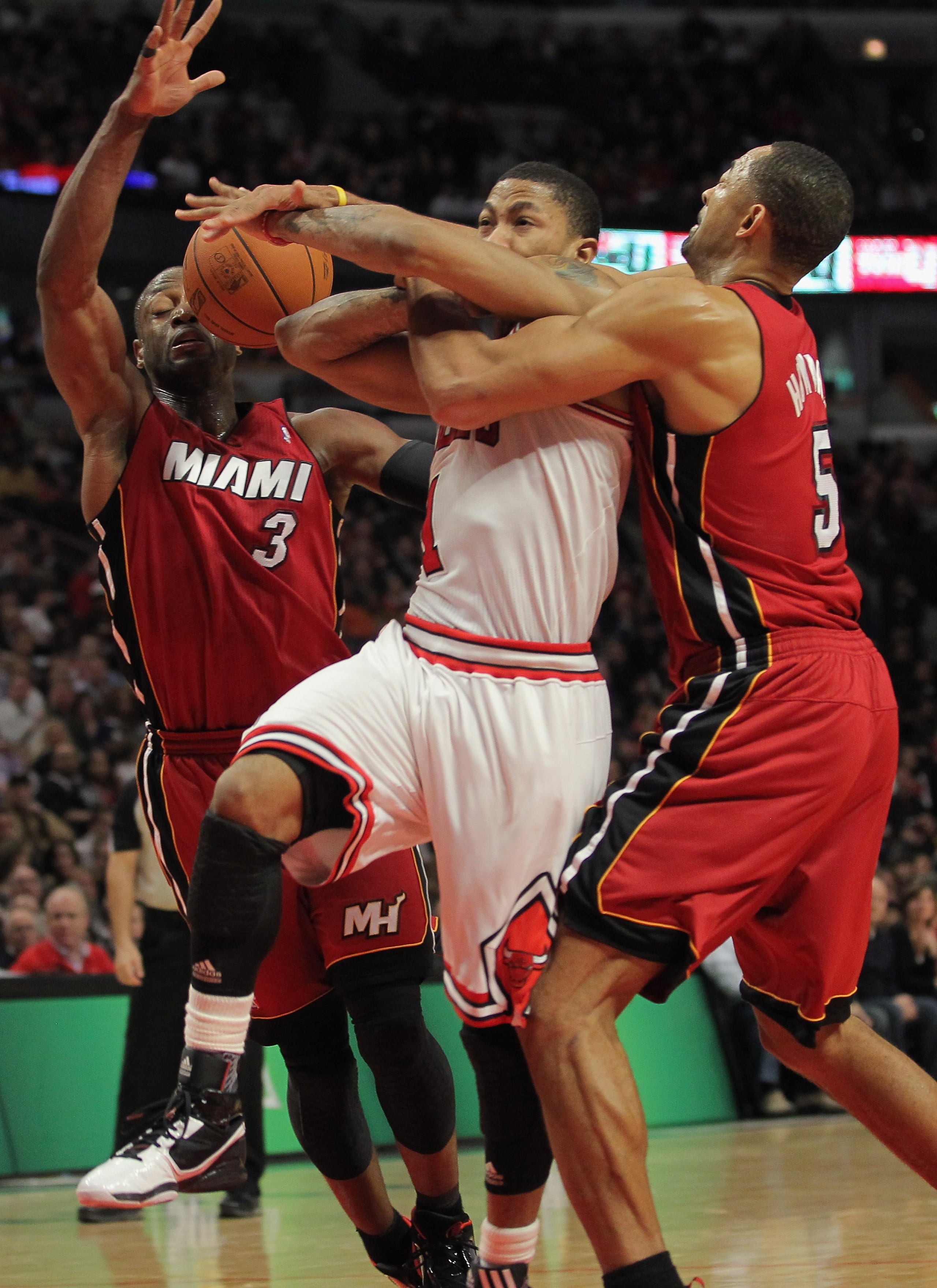 CHICAGO, IL - JANUARY 15: Derrick Rose #1 of the Chicago Bulls looses control of the ball as he is fouled by Juwan Howard (R) #5 of the Miami Heat as Dwyane Wade (L) #3 of the Heat follows the action at the United Center on January 15, 2011 in Chicago, I CHICAGO, IL - JANUARY 15: Derrick Rose #1 of the Chicago Bulls looses control of the ball as he is fouled by Juwan Howard (R) #5 of the Miami Heat as Dwyane Wade (L) #3 of the Heat follows the action at the United Center on January 15, 2011 in Chicago, I