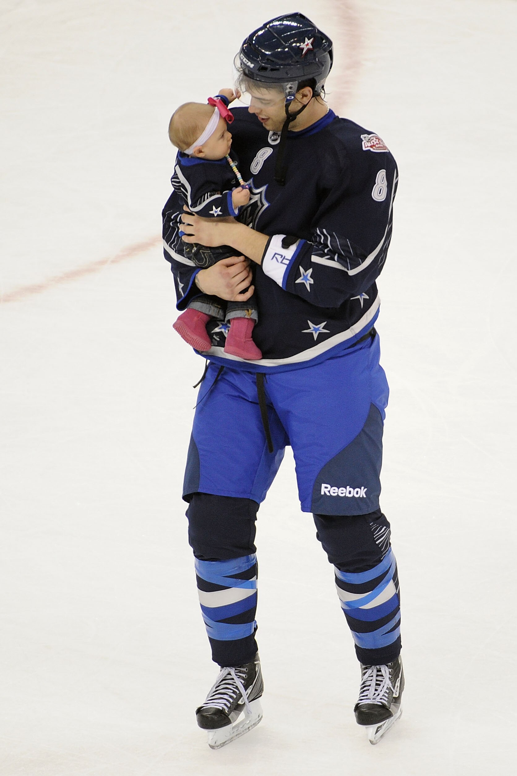 RALEIGH, NC - JANUARY 30:  Brent Burns #8 of the Minnesota Wild and Team Lidstrom holds his daughter Peyton after they defeated Team Staal 11 to 10 in the 58th NHL All-Star Game at RBC Center on January 30, 2011 in Raleigh, North Carolina.  (Photo by Harr