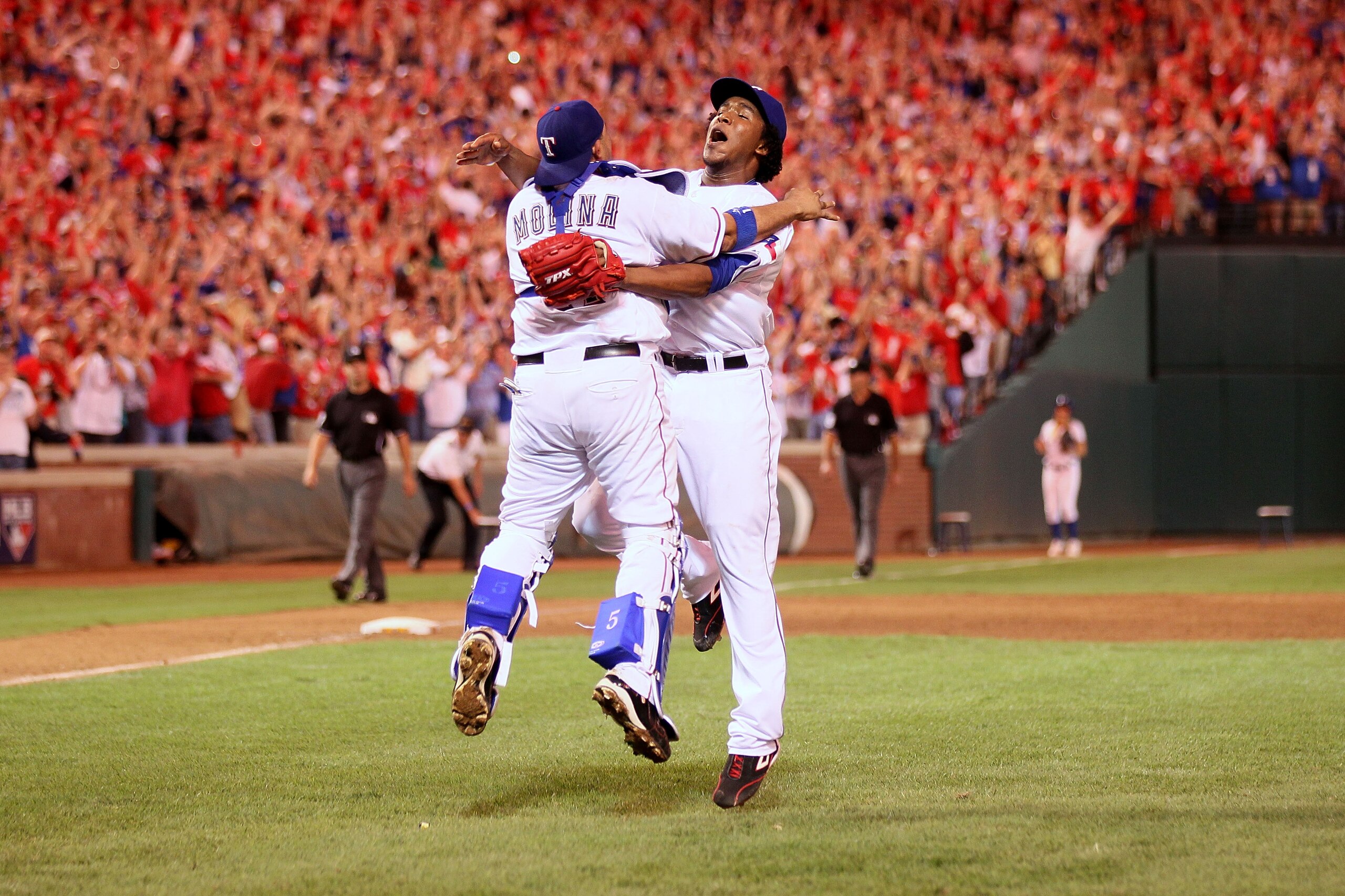 ARLINGTON, TX - OCTOBER 22: Bengie Molina #11 and Neftali Feliz #30 of the Texas Rangers celebrate after defeating the New York Yankees 6-1 in Game Six of the ALCS to advance to the World Series during the 2010 MLB Playoffs at Rangers Ballpark in Arlingt ARLINGTON, TX - OCTOBER 22: Bengie Molina #11 and Neftali Feliz #30 of the Texas Rangers celebrate after defeating the New York Yankees 6-1 in Game Six of the ALCS to advance to the World Series during the 2010 MLB Playoffs at Rangers Ballpark in Arlingt
