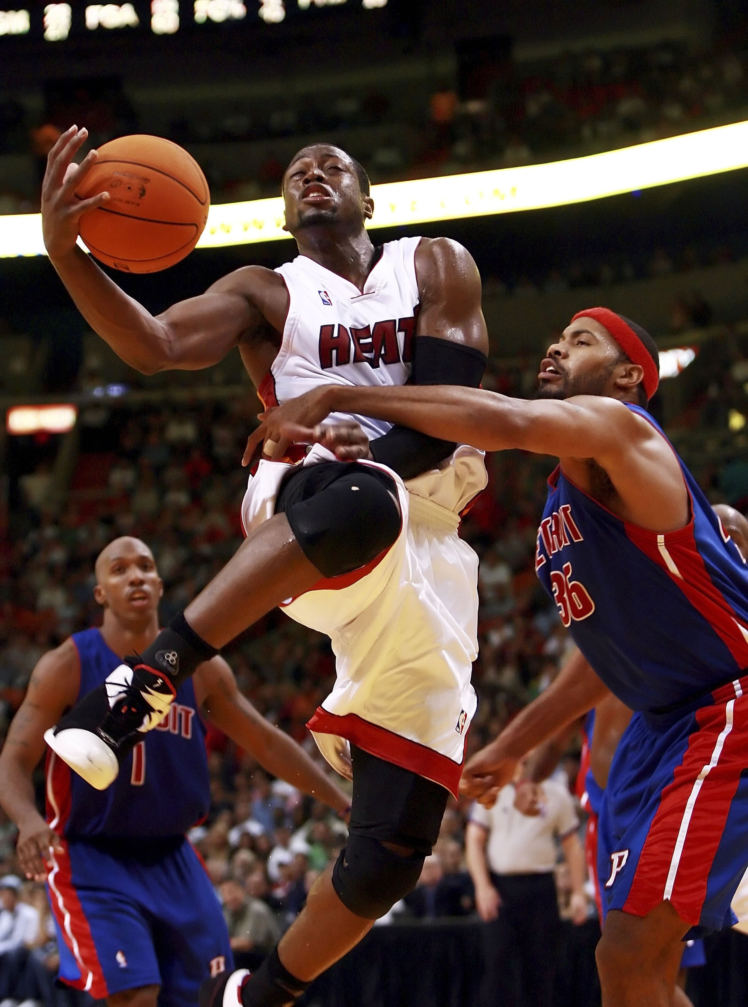 MIAMI - NOVEMBER 30:  Rasheed Wallace #36 of the Detroit Pistons fouls Dwyane Wade #3 of the Miami Heat at American Airlines Arena on November 30, 2006 in Miami, Florida. The Pistons defeated the Heat 87-85. NOTE TO USER: User expressly acknowledges and a