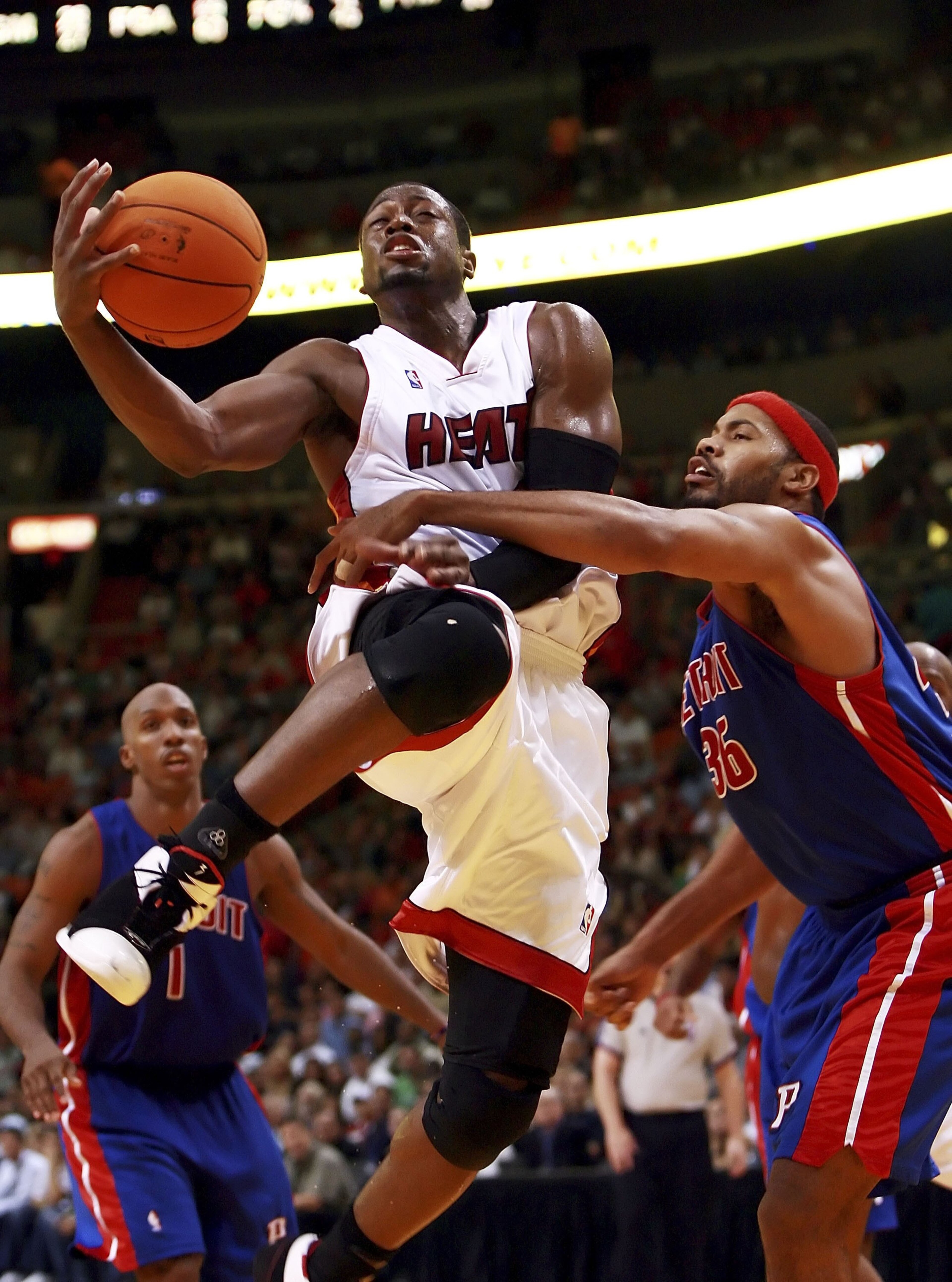 MIAMI - NOVEMBER 30:  Rasheed Wallace #36 of the Detroit Pistons fouls Dwyane Wade #3 of the Miami Heat at American Airlines Arena on November 30, 2006 in Miami, Florida. The Pistons defeated the Heat 87-85. NOTE TO USER: User expressly acknowledges and a