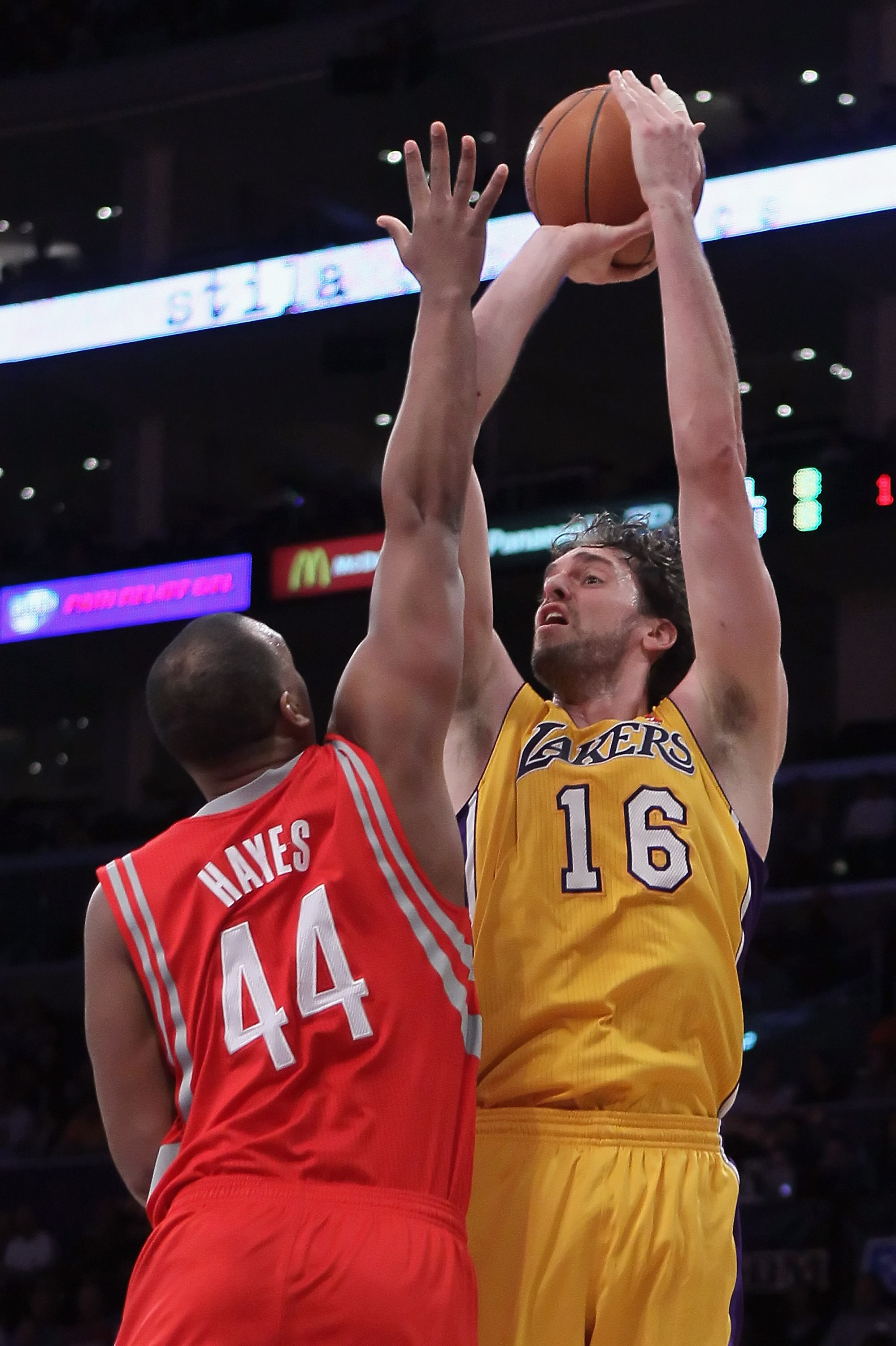 LOS ANGELES, CA - FEBRUARY 01:  Pau Gasol #16 of the Los Angeles Lakers shoots over Chuck Hayes #44 of the Houston Rockets in the first half at Staples Center on February 1, 2011 in Los Angeles, California. The Lakers defeated the Rockets 114-106. NOTE TO