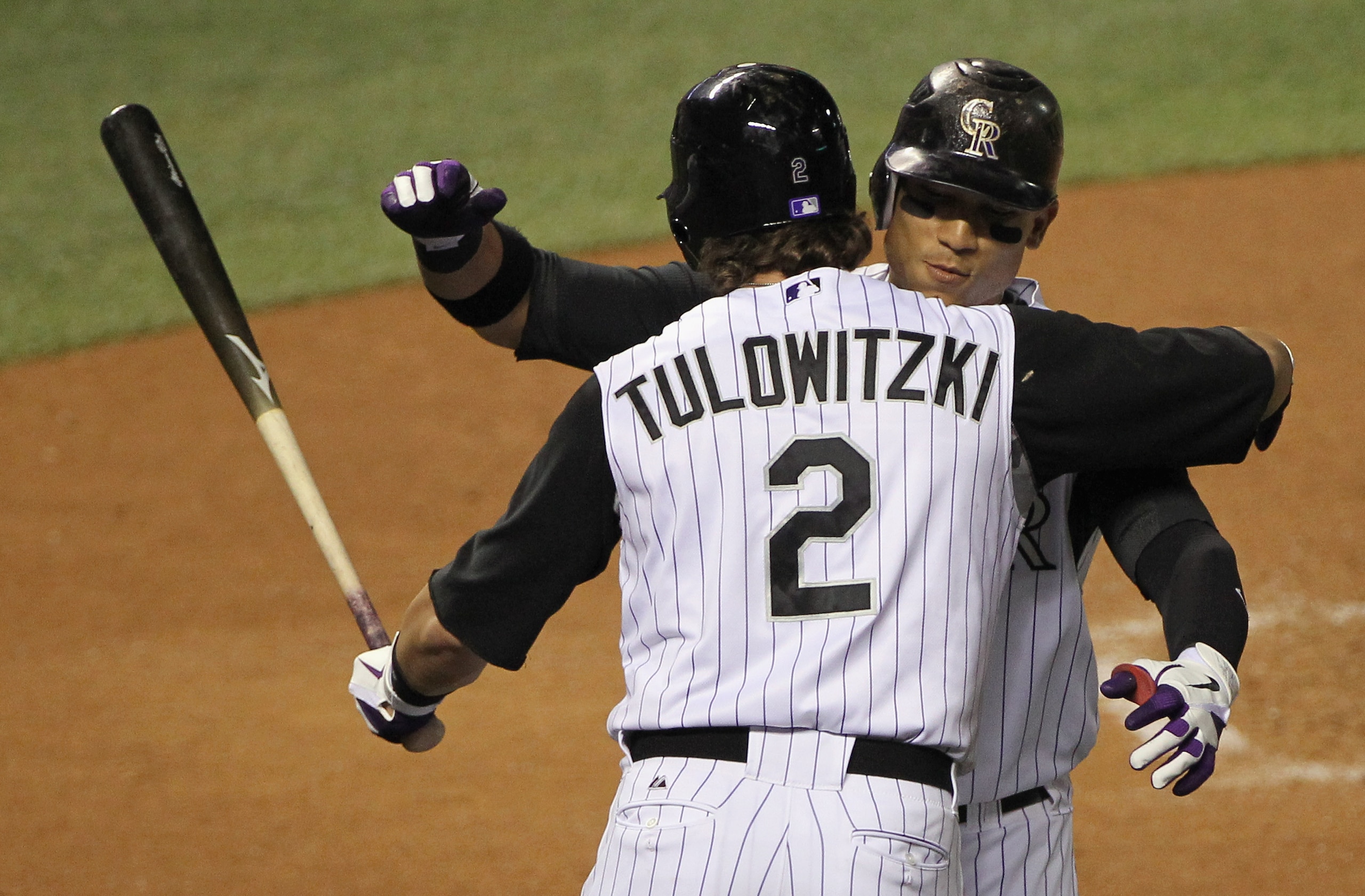 DENVER - SEPTEMBER 27:  Troy Tulowitzki #2 welcomes Carlos Gonzalez #5 of the Colorado Rockies home after his solo home run against the Los Angeles Dodgers at Coors Field on September 25, 2010 in Denver, Colorado.  (Photo by Doug Pensinger/Getty Images)