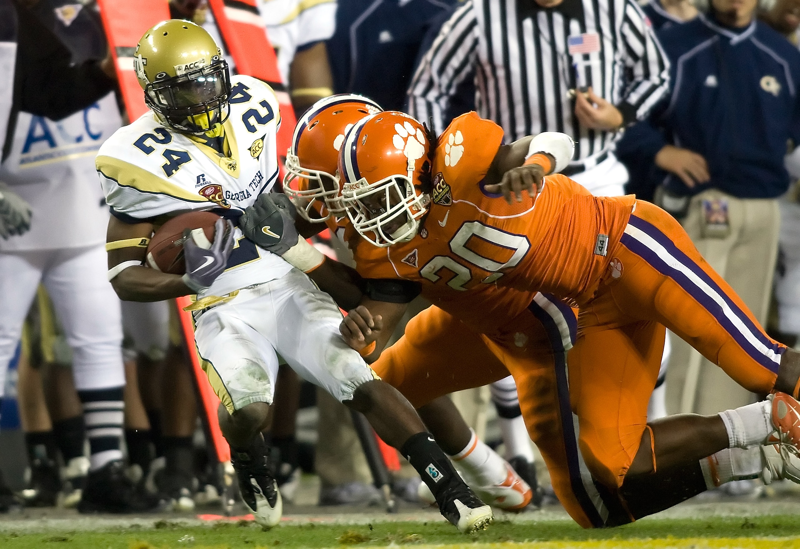 TAMPA, FL - DECEMBER 05:  Defenders Mallicah Goodman #97 and Brandon Maye  #20 of the Clemson Tigers tackle running back Embry Peeples #24 of the Georgia Tech Yellow Jackets in the 2009 ACC Football Championship game at Raymond James Stadium on December 5