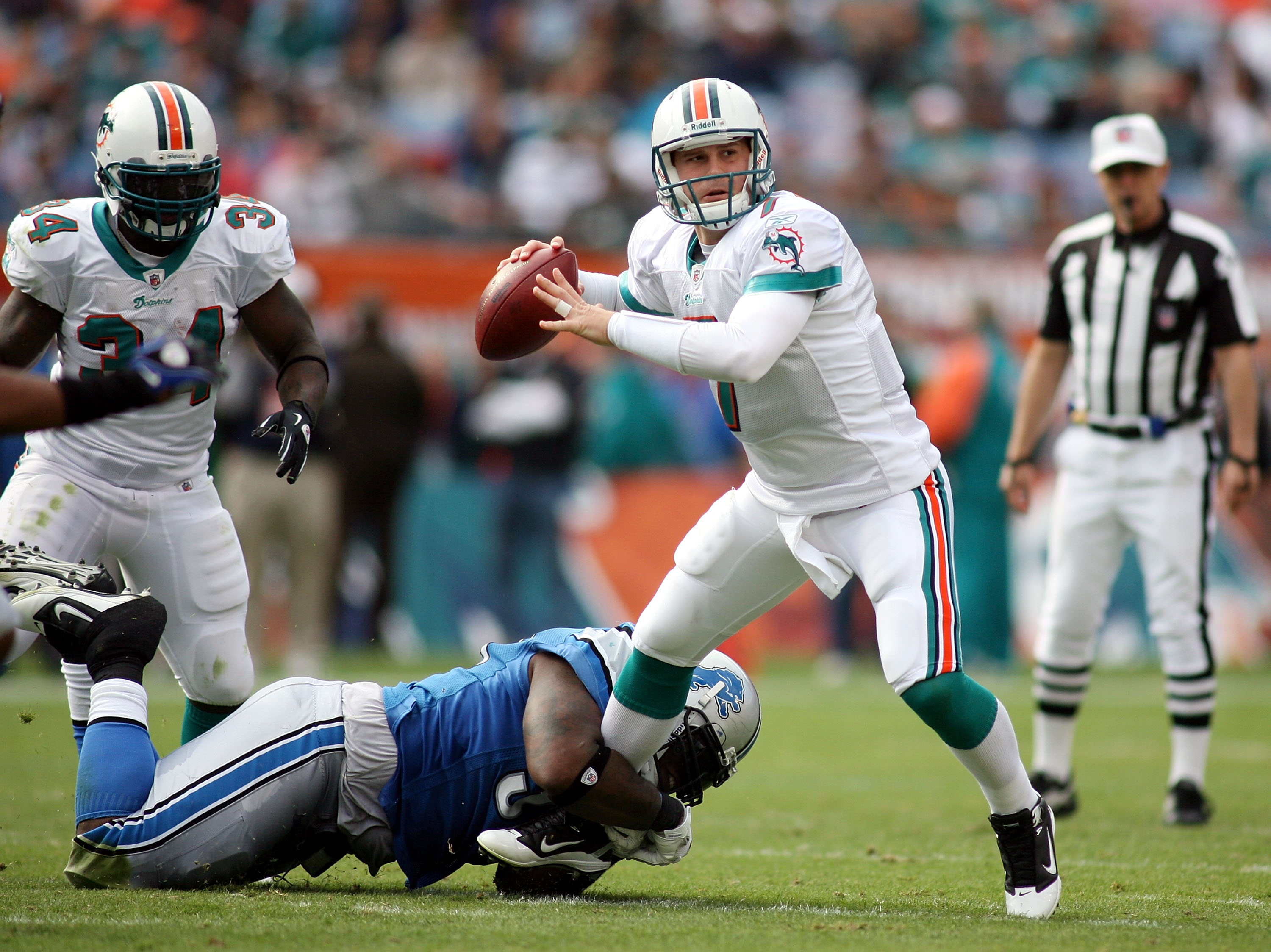 MIAMI - DECEMBER 26: Quarterback Chad Henne #7 of the Miami Dolphins is preasured by Lawrence Jackson #94 of the Detroit Lions at Sun Life Stadium on December 26, 2010 in Miami, Florida. (Photo by Marc Serota/Getty Images)