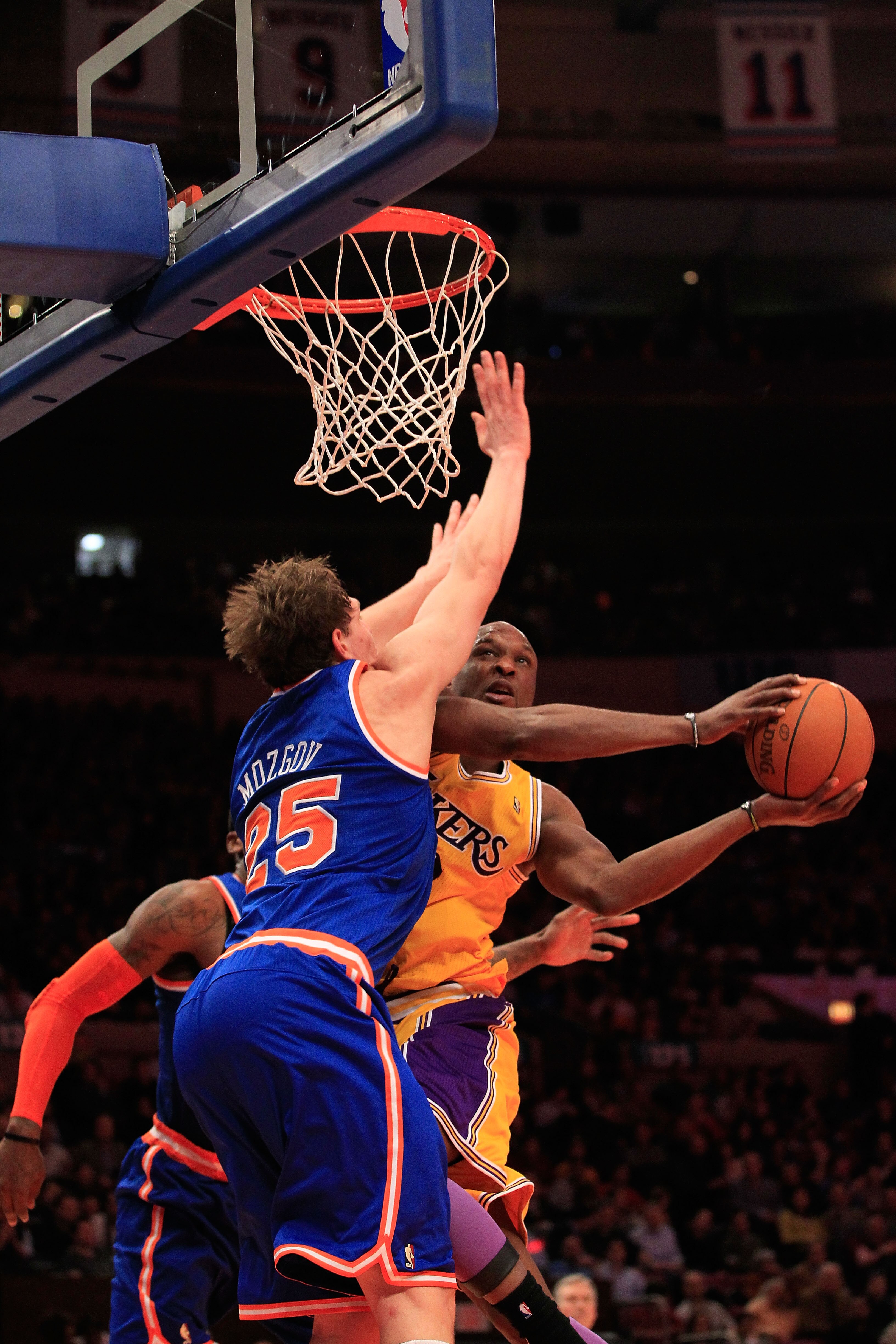 NEW YORK, NY - FEBRUARY 11: Lamar Odum #7 of the Los Angeles Lakers shoots over Timofey Mozgov #25 of the New York Knicks at Madison Square Garden on February 11, 2011 in New York City. NOTE TO USER: User expressly acknowledges and agrees that, by downloa