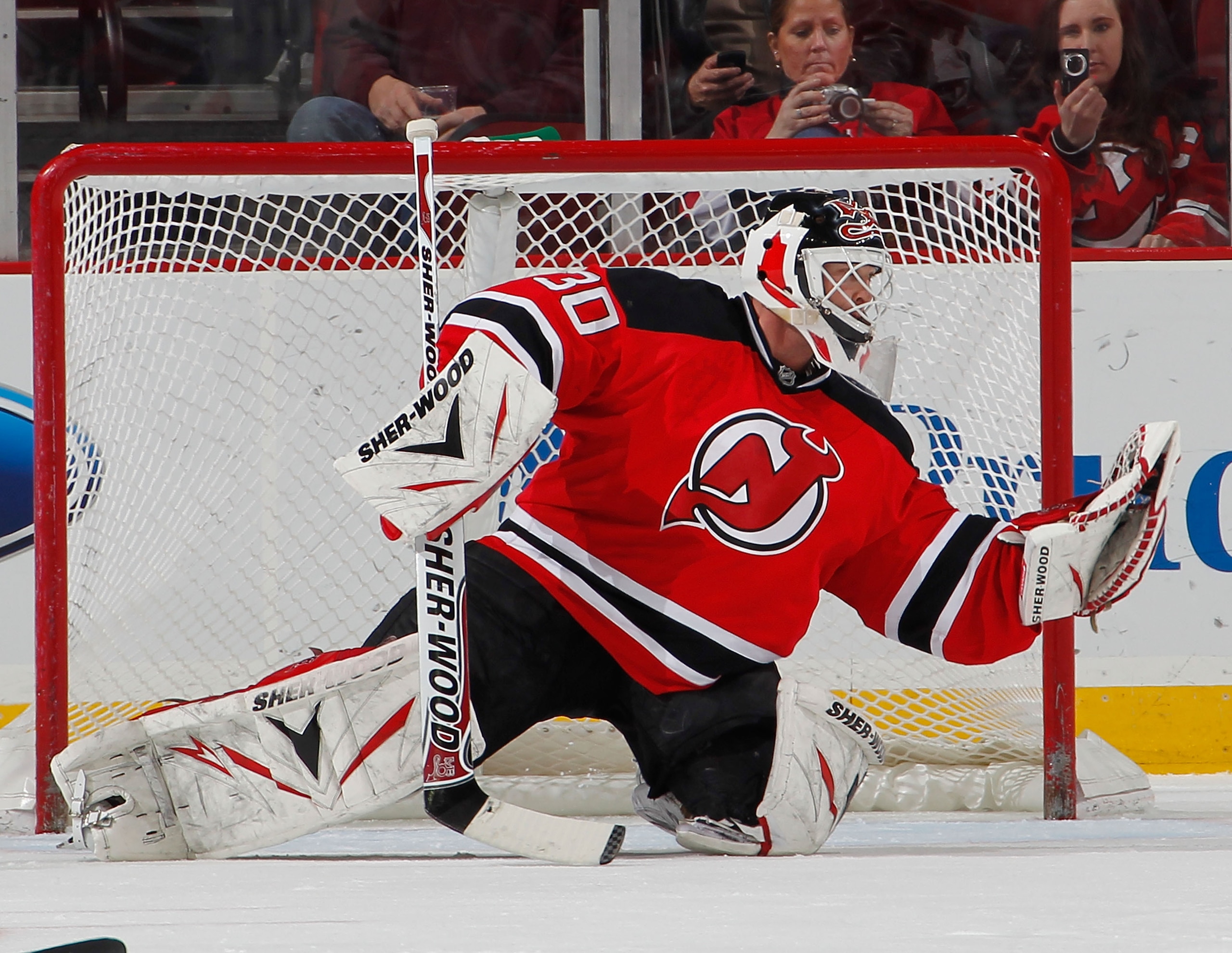 NEWARK, NJ - FEBRUARY 01:  Goalie Martin Brodeur #30 of the New Jersey Devils makes a glove save during an NHL hockey game against the Ottawa Senators at the Prudential Center on February 1, 2011 in Newark, New Jersey.  (Photo by Paul Bereswill/Getty Imag