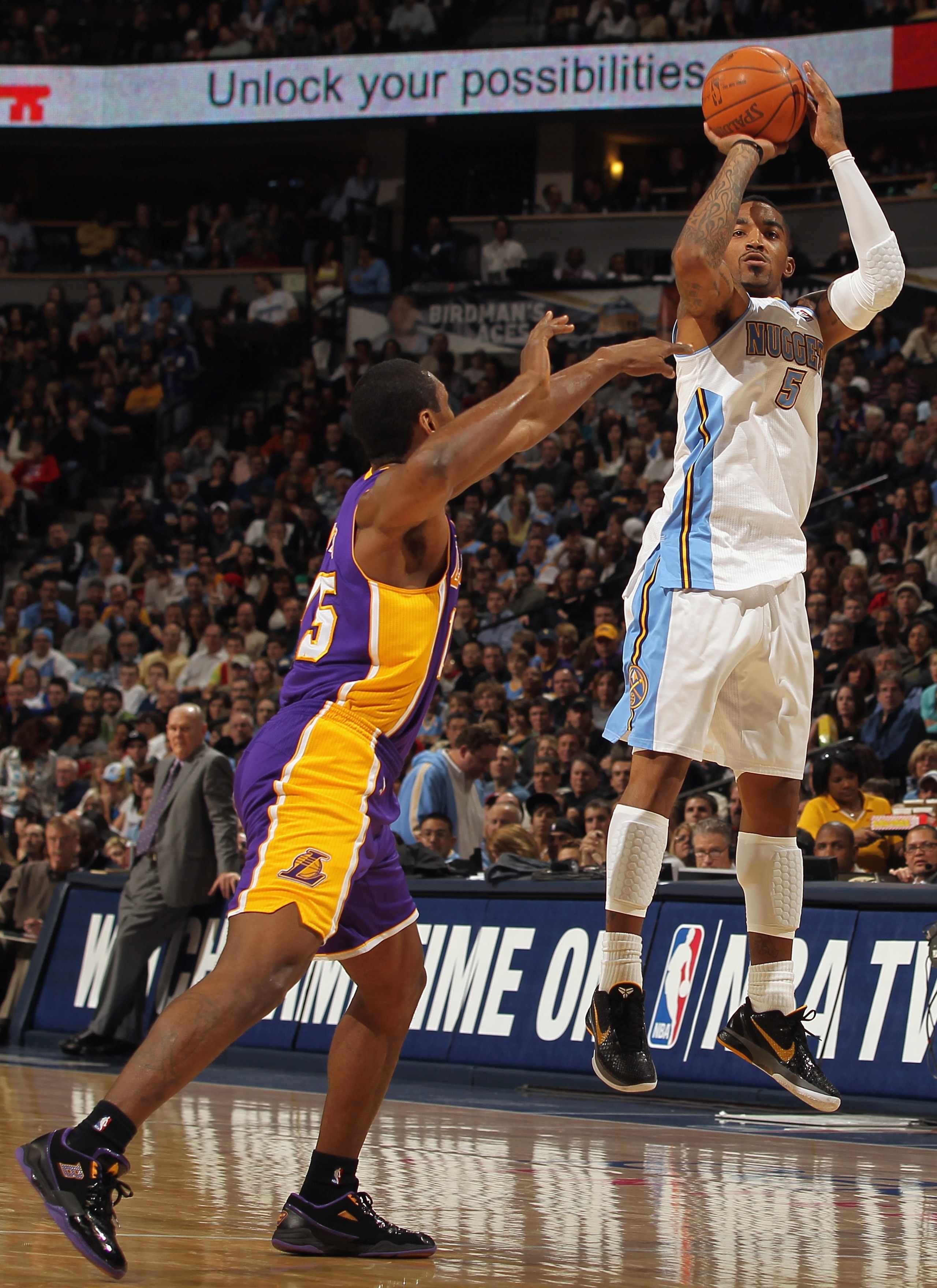 DENVER, CO - JANUARY 21: J.R. Smith #5 of the Denver Nuggets takes a shot against Ron Artest #15 of the Los Angeles Lakers at the Pepsi Center on January 21, 2011 in Denver, Colorado. The Lakers defeated the Nuggets 107-97. NOTE TO USER: User expressly a DENVER, CO - JANUARY 21: J.R. Smith #5 of the Denver Nuggets takes a shot against Ron Artest #15 of the Los Angeles Lakers at the Pepsi Center on January 21, 2011 in Denver, Colorado. The Lakers defeated the Nuggets 107-97. NOTE TO USER: User expressly a