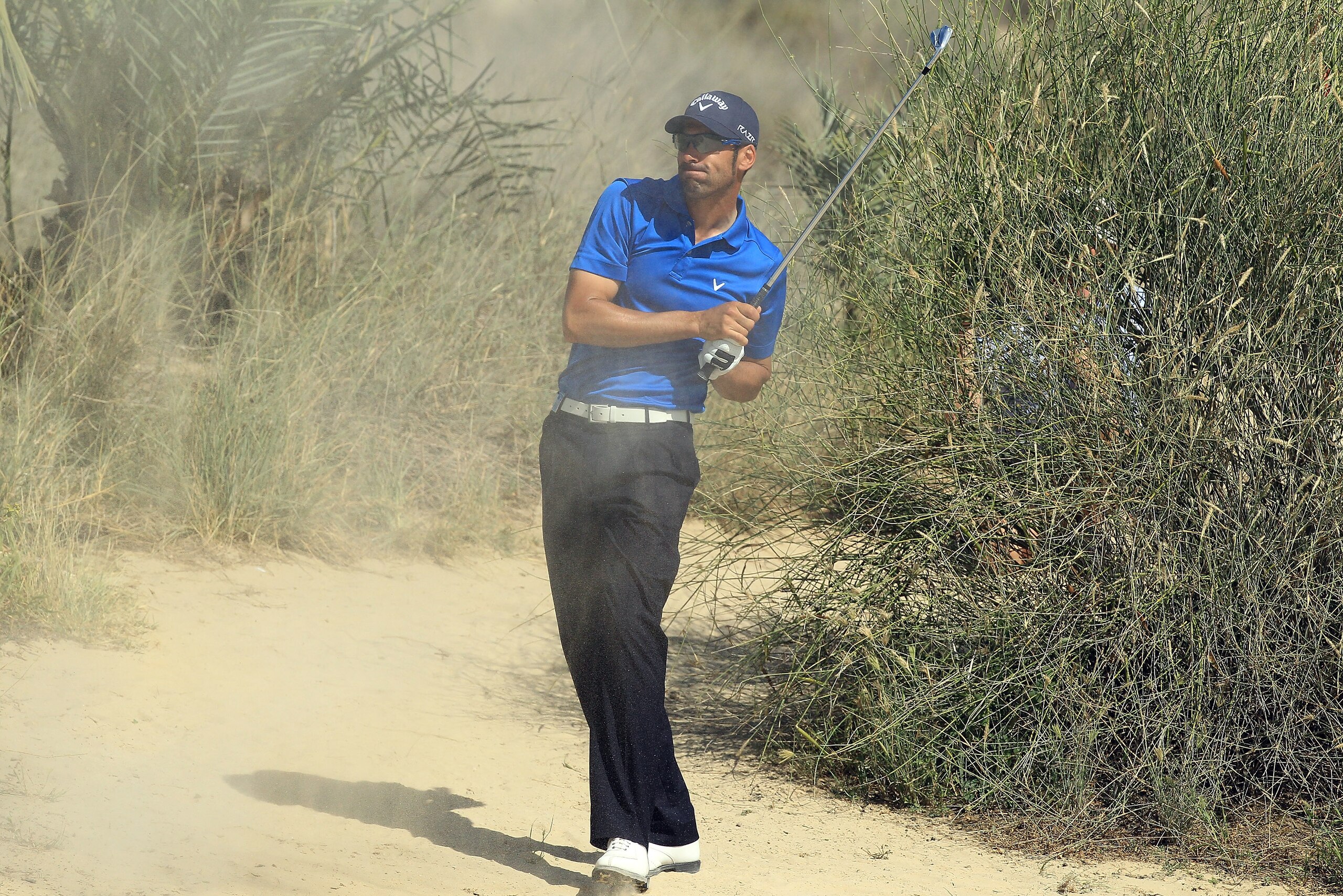 DUBAI, UNITED ARAB EMIRATES - FEBRUARY 13: Alvaro Quiros of Spain plays his third shot at the par 4, 8th hole during the final round of the 2011 Omega Dubai Desert Classic on the Majilis Course at the Emirates Golf Club on February 13, 2011 in Dubai, Unit