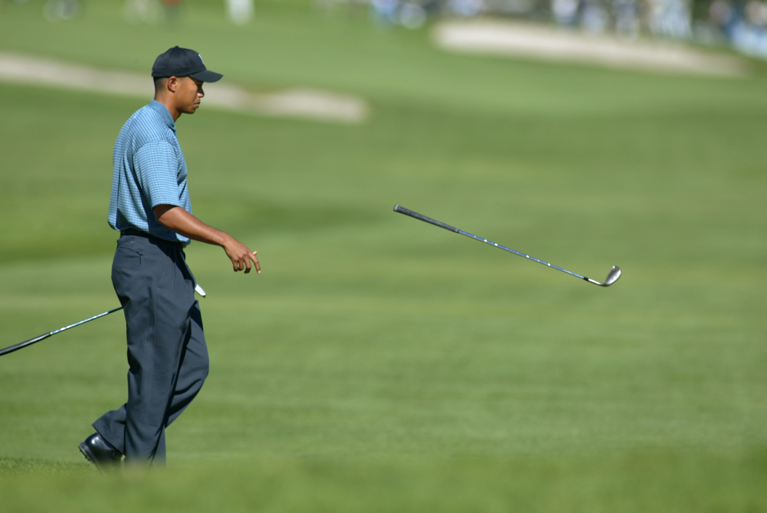 PACIFIC PALISADES, CA - FEBRUARY 20:  Tiger Woods tosses his club after a shot during the first round of the Nissan Open on February 20, 2003 at Riveria C.C. in Pacific Palisades, California.  (Photo by Scott Halleran/Getty Images)