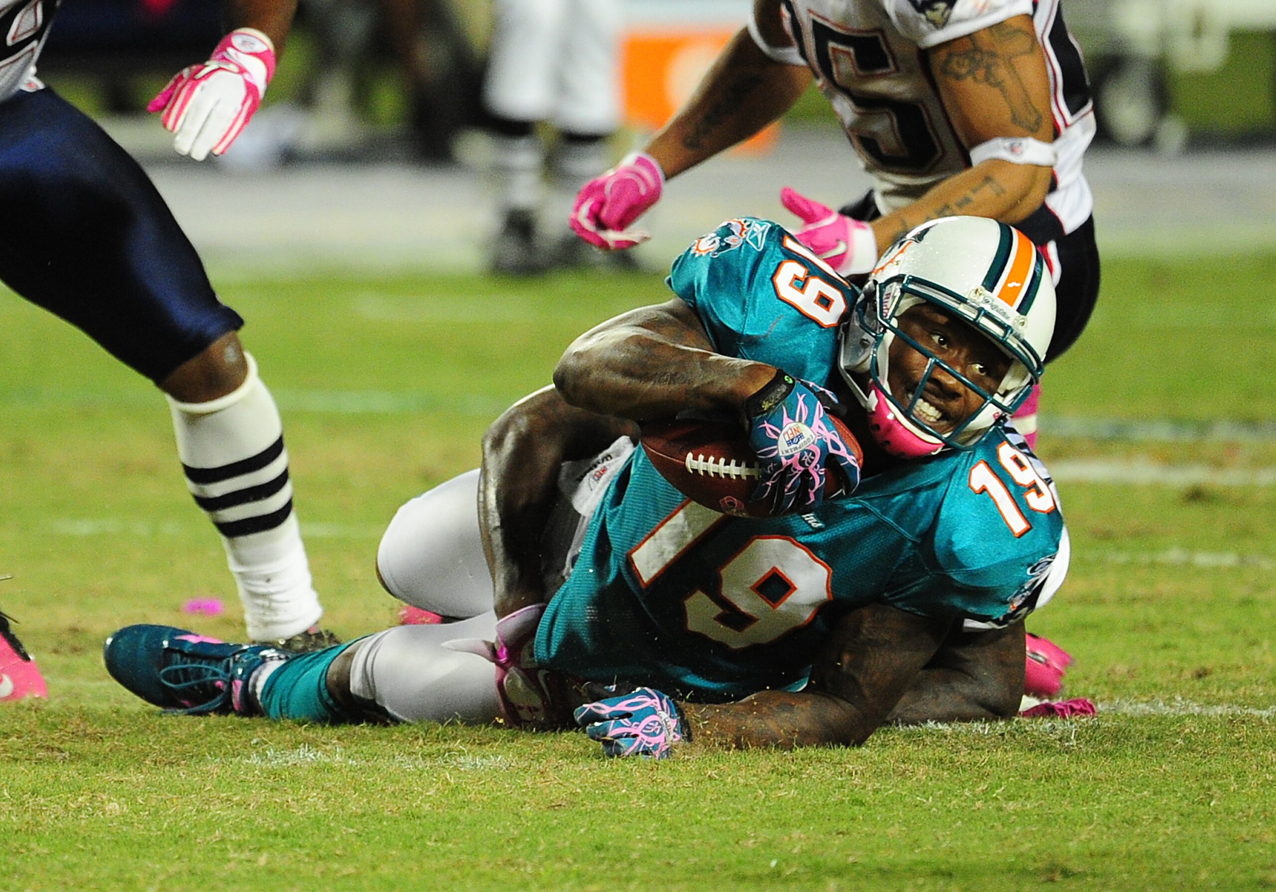 MIAMI - OCTOBER 4: Brandon Marshall #19 of the Miami Dolphins is tackled by Kyle Arrington #27 of the New England Patriots at Sun Life Field on October 4, 2010 in Miami, Florida. (Photo by Scott Cunningham/Getty Images) MIAMI - OCTOBER 4: Brandon Marshall #19 of the Miami Dolphins is tackled by Kyle Arrington #27 of the New England Patriots at Sun Life Field on October 4, 2010 in Miami, Florida. (Photo by Scott Cunningham/Getty Images)