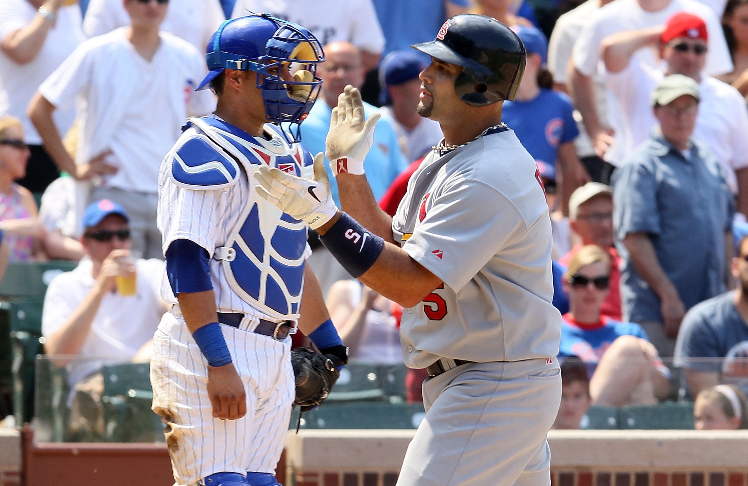 CHICAGO - MAY 30:  Albert Pujols #5 of the St. Louis Cardinals celebrates a home run as Geovany Soto #18 the Chicago Cubs looks on on May 30, 2010 at Wrigley Field in Chicago, Illinois.  (Photo by Jim McIsaac/Getty Images)