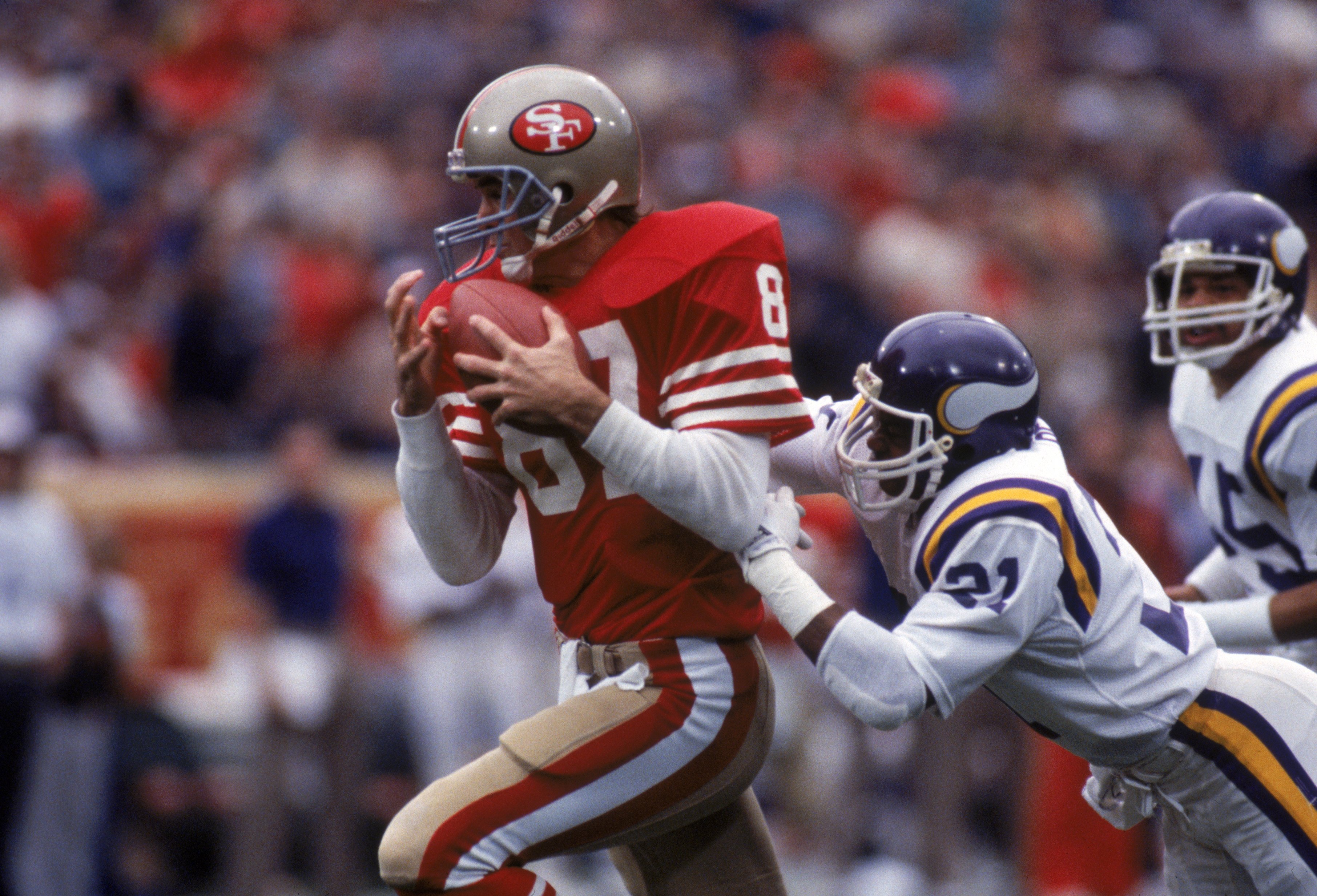 SAN FRANCISCO - DECEMBER 8:  Wide receiver Dwight Clark #87 of the San Francisco 49ers catches a pass against defensive back Rufus Bess #21 of the Minnesota Vikings during a game at Candlestick Park on December 8, 1984 in San Francisco, California.  The 4