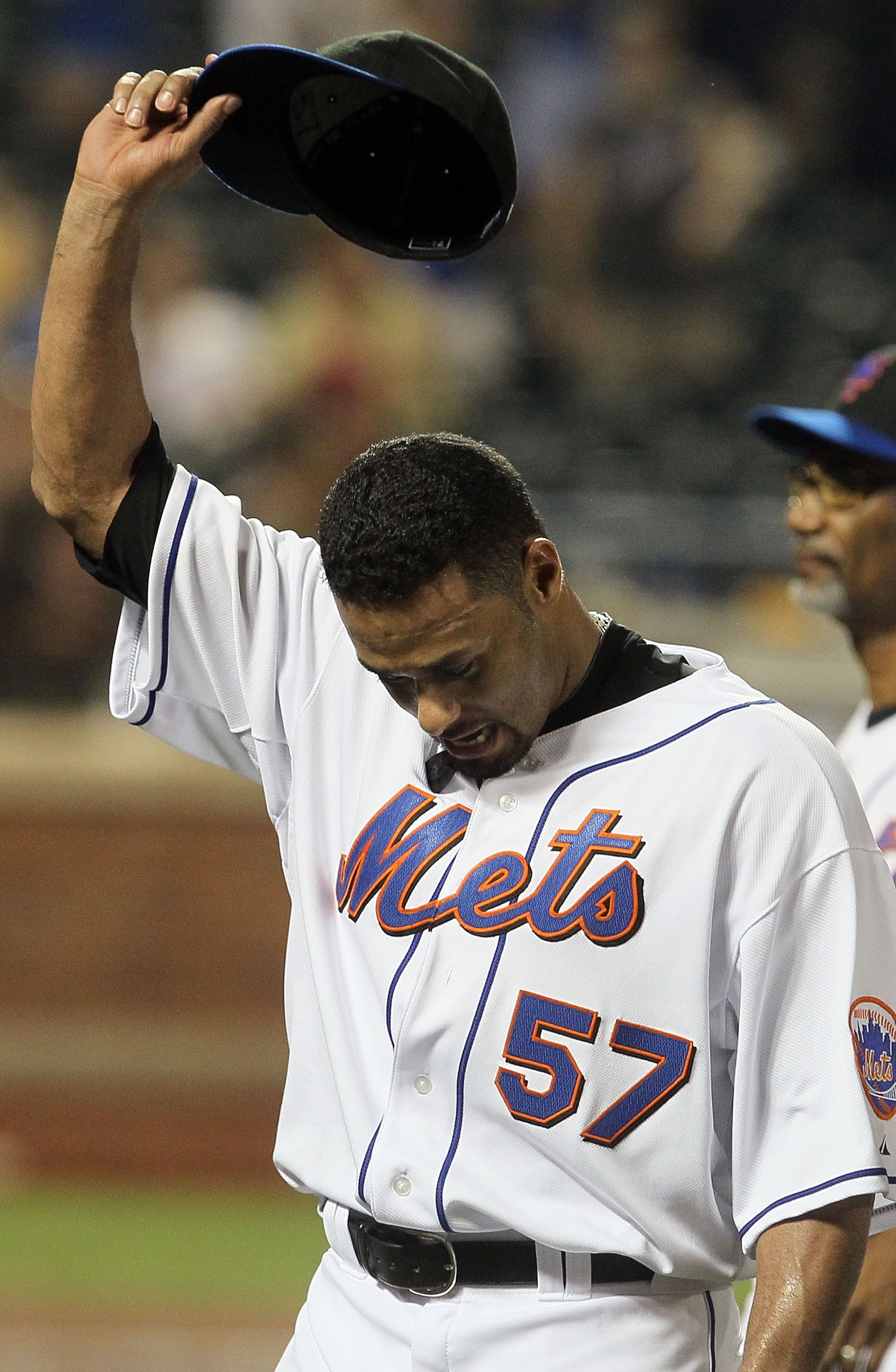 NEW YORK - JULY 06:  Johan Santana #57 of the New York Mets salutes the crowd as he walks off the field after pitching a shutout against the Cincinnati Reds on July 6, 2010 at Citi Field in the Flushing neighborhood of the Queens borough of New York City.