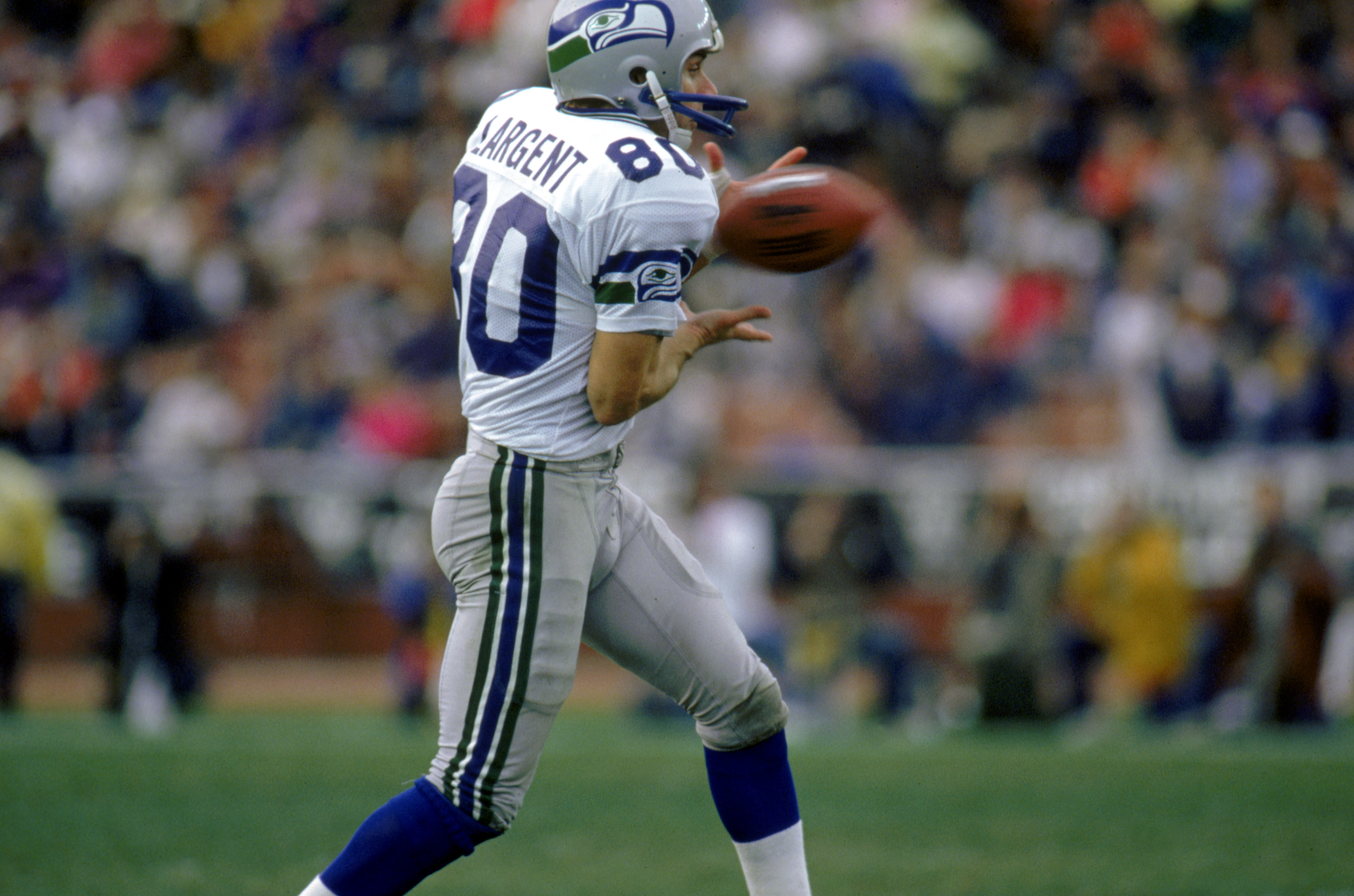 LOS ANGELES - DECEMBER 18:  Wide receiver Steve Largent #80 of the Seattle Seahawks catches a pass during a game against the Los Angeles Raiders at the L.A. Coliseum on December 18, 1988 in Los Angeles, California.  The Seahawks defeated the Raiders 43-37