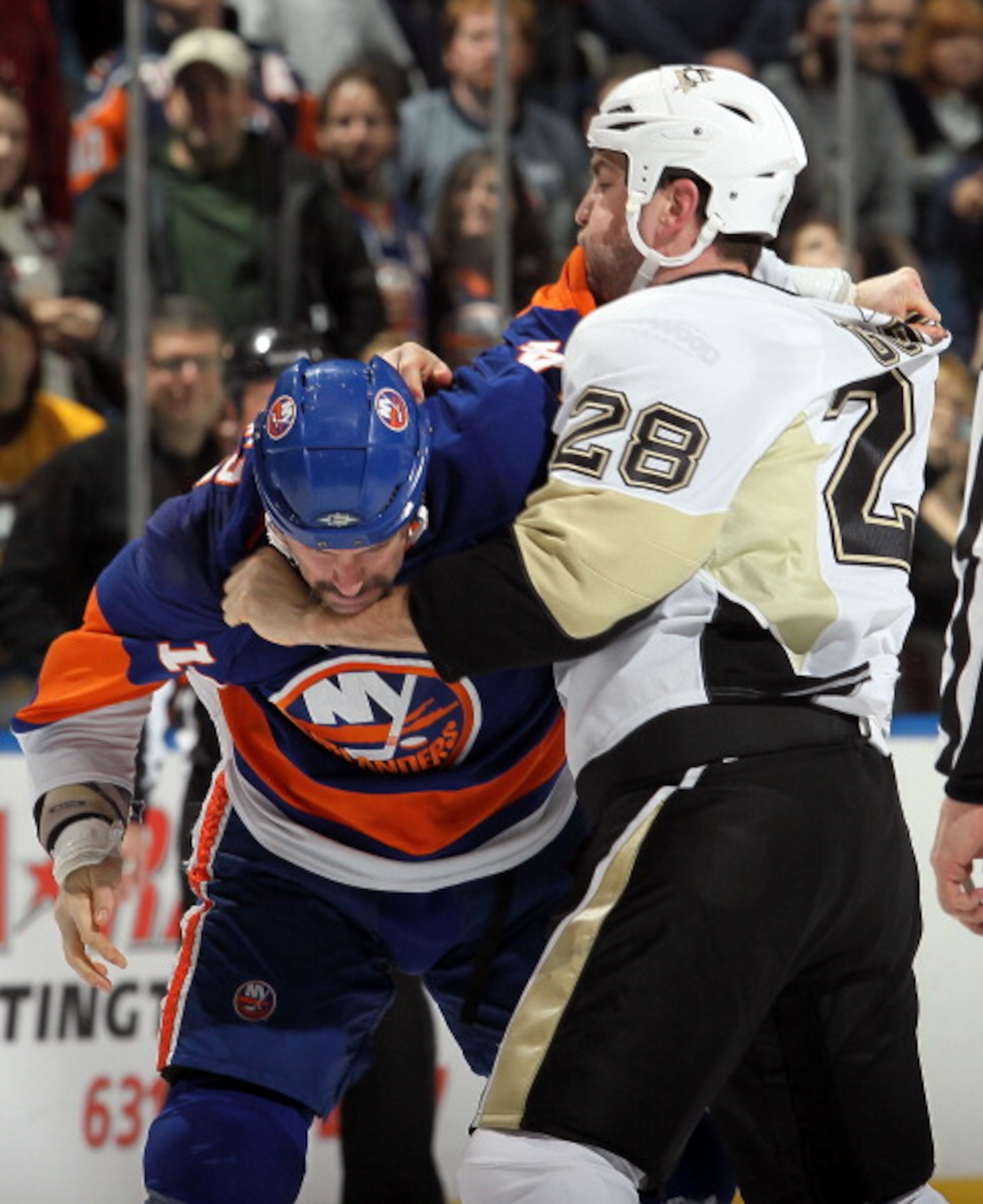 UNIONDALE, NY - FEBRUARY 11:  Eric Godard #28 of the Pittsburgh Penguins fights Trevor Gillies #14 of the New York Islanders during the first period on February 11, 2011 at Nassau Coliseum in Uniondale, New York.  (Photo by Jim McIsaac/Getty Images)