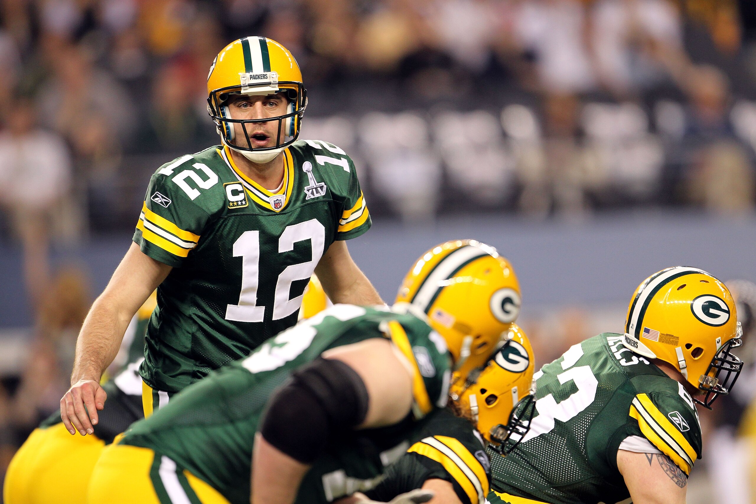 ARLINGTON, TX - FEBRUARY 06:  Quarterback Aaron Rodgers #12 of the Green Bay Packers looks down the line of scrimmage against the Pittsburgh Steelers during Super Bowl XLV at Cowboys Stadium on February 6, 2011 in Arlington, Texas. The Packers won 31-25.