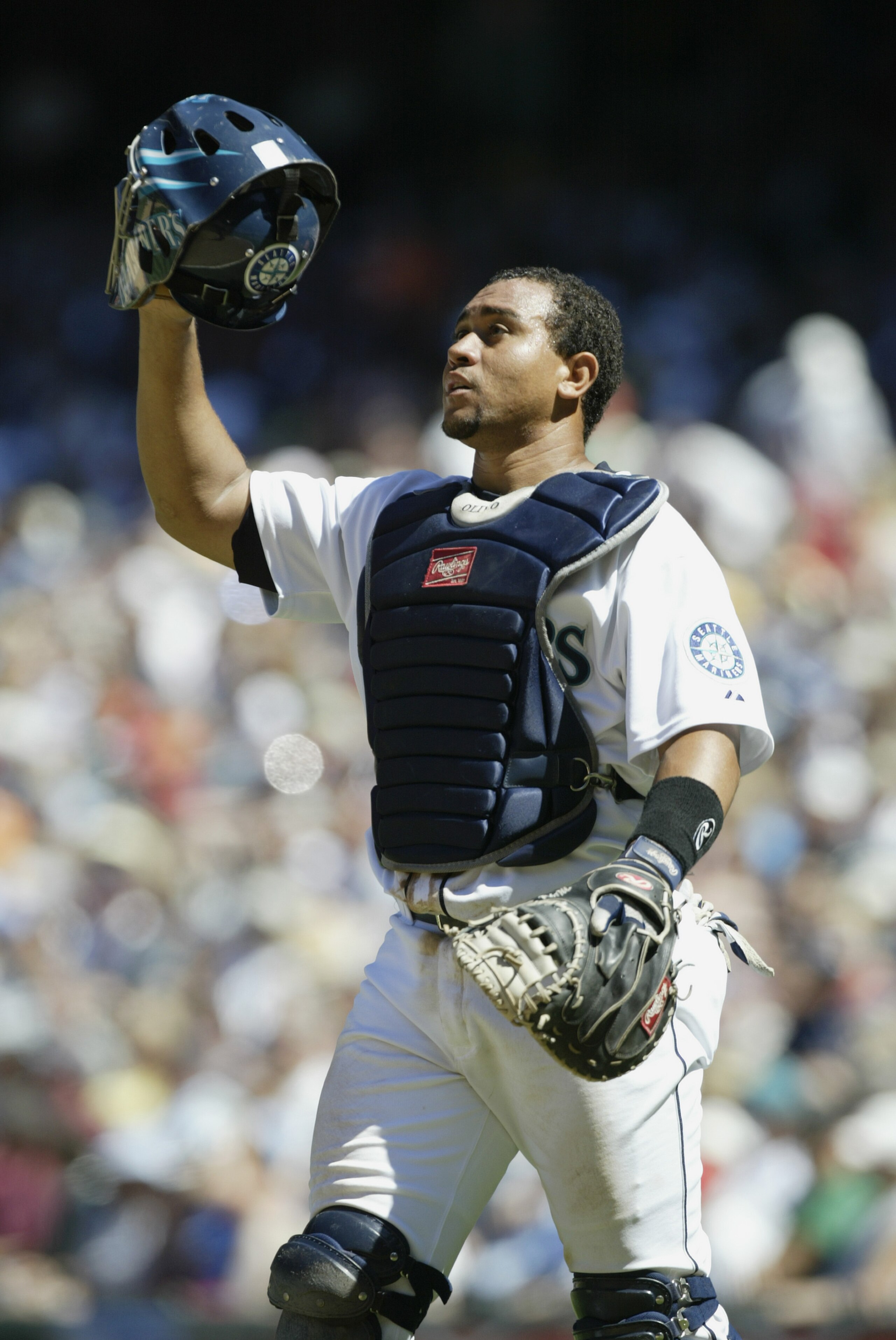 SEATTLE - JULY 17:  Catcher Miguel Olivo #8 of the Seattle Mariners adjusts his mask against the Baltimore Orioles during the MLB game on July 17, 2005 at Safeco Field in Seattle Washington. The Mariners defeated the Orioles 8-2.  (Photo by Otto Greule Jr