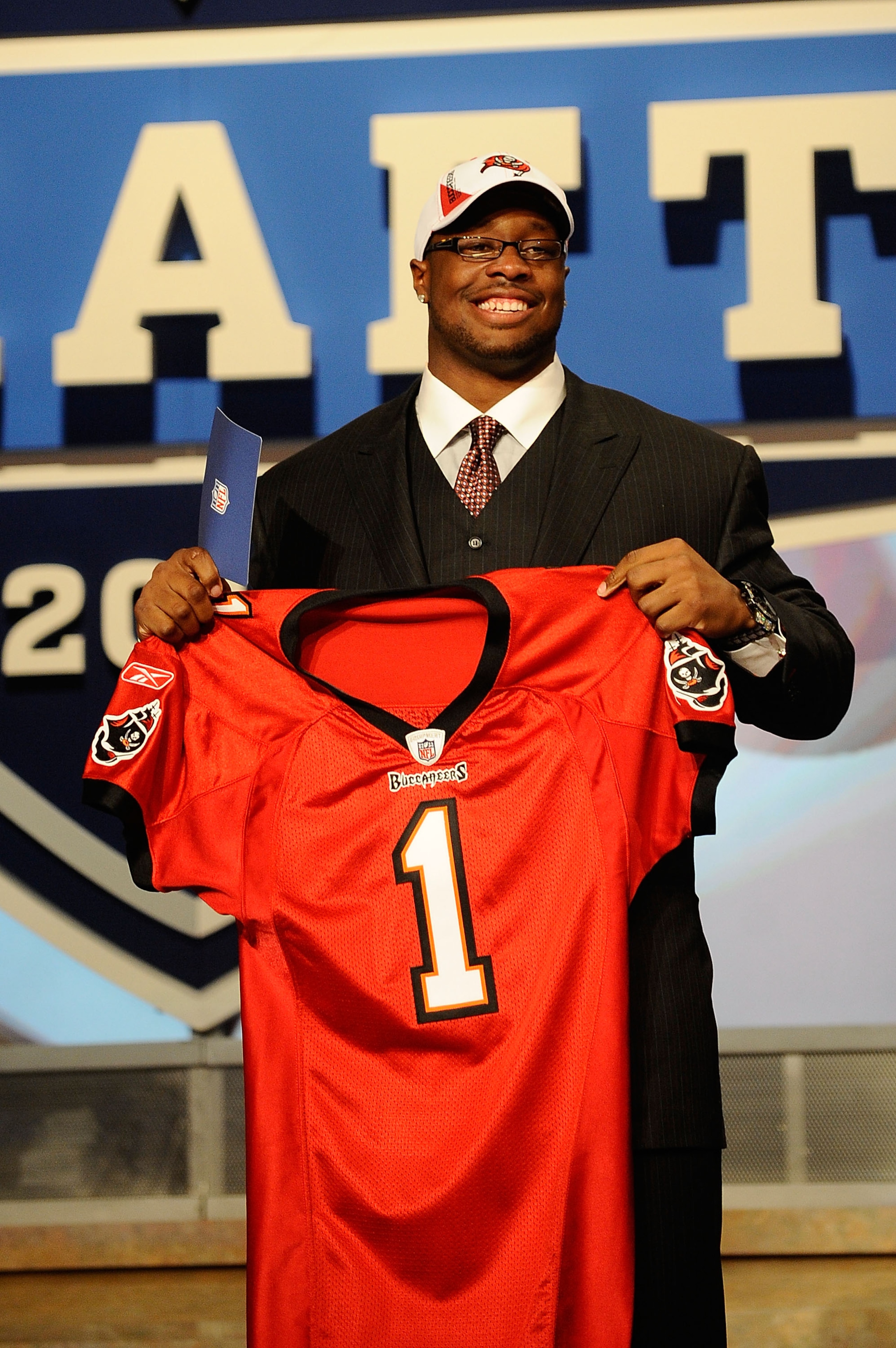 NEW YORK - APRIL 22:  Gerald McCoy (R) of the Oklahoma Sooners celebrates as he holds a Tampa Bay Buccaneers jersey after he was picked third overall by Tampa Bay during the 2010 NFL Draft at Radio City Music Hall on April 22, 2010 in New York City.  (Pho