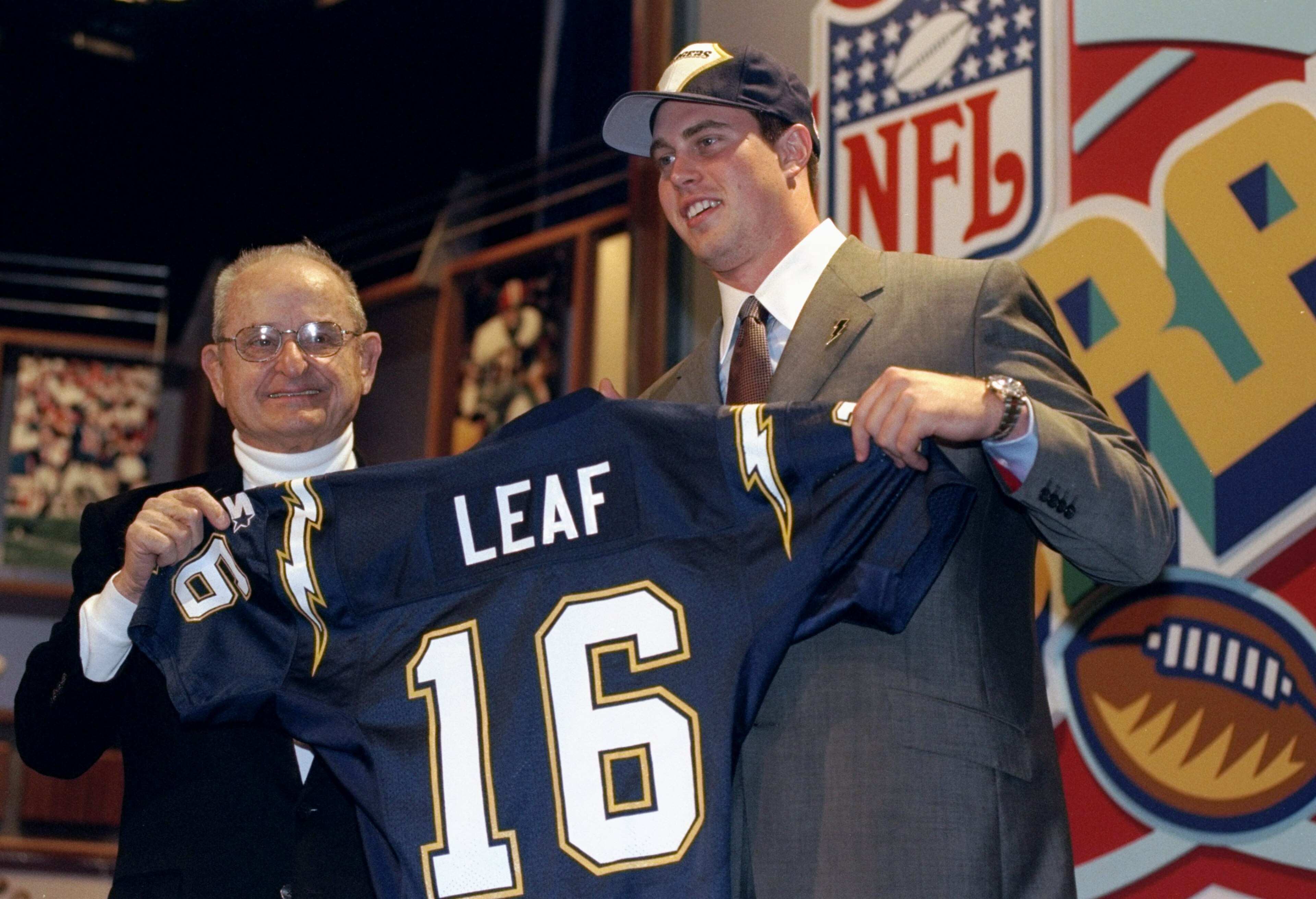 18 Apr 1998: Second overall pick Ryan Leaf shows off his jersey alongside Alex Spanos after being selected by the San Diego Chargers in the first round of the 1998 NFL Draft at Madison Square Garden in Manhattan, New York. Mandatory Credit: Ezra C. Shaw 18 Apr 1998: Second overall pick Ryan Leaf shows off his jersey alongside Alex Spanos after being selected by the San Diego Chargers in the first round of the 1998 NFL Draft at Madison Square Garden in Manhattan, New York. Mandatory Credit: Ezra C. Shaw