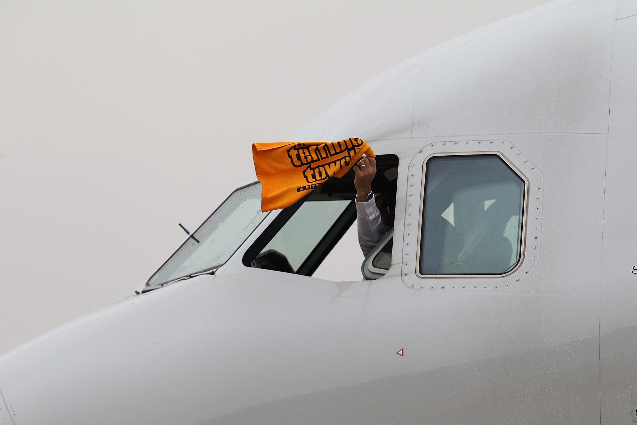 DALLAS, TX - JANUARY 31: A US Airway pilot waves 'the terrible towel' as he taxis the plane with the AFC Championship Pittsburgh Steelers at Dallas Fort Worth International Airport on January 31, 2011 in Dallas, Texas. The Pittsburgh Steelers will play DALLAS, TX - JANUARY 31: A US Airway pilot waves 'the terrible towel' as he taxis the plane with the AFC Championship Pittsburgh Steelers at Dallas Fort Worth International Airport on January 31, 2011 in Dallas, Texas. The Pittsburgh Steelers will play