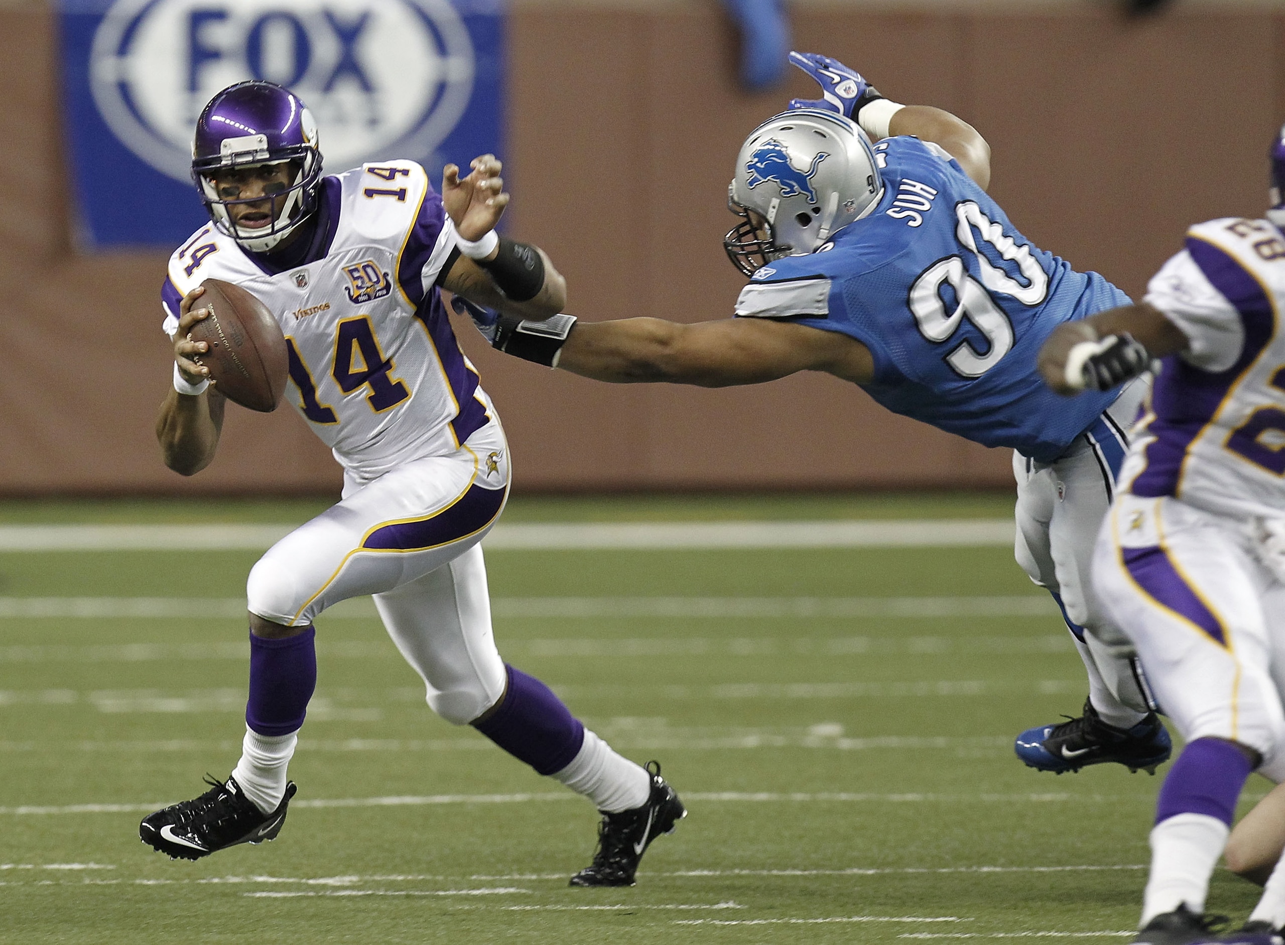DETROIT, MI - JANUARY 02:  Joe Webb #14 of the Minnesota Vikings runs around the tackle of Ndamukong Suh #90 of the Detroit Lions at Ford Field on January 2, 2011 in Detroit, Michigan.  (Photo by Gregory Shamus/Getty Images)