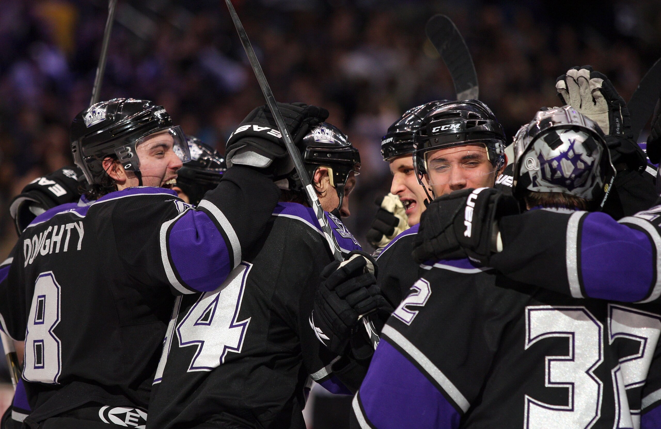 LOS ANGELES, CA - JANUARY 26:  (L-R)Drew Doughty #8, Ryan Smyth #94, Kyle Clifford #13 and Alec Martinez #53 and goaltender Jonathan Quick #32 of the Los Angeles Kings celebrate after defeating the San Jose Sharks 3-2 in shootout overtime at Staples Cente