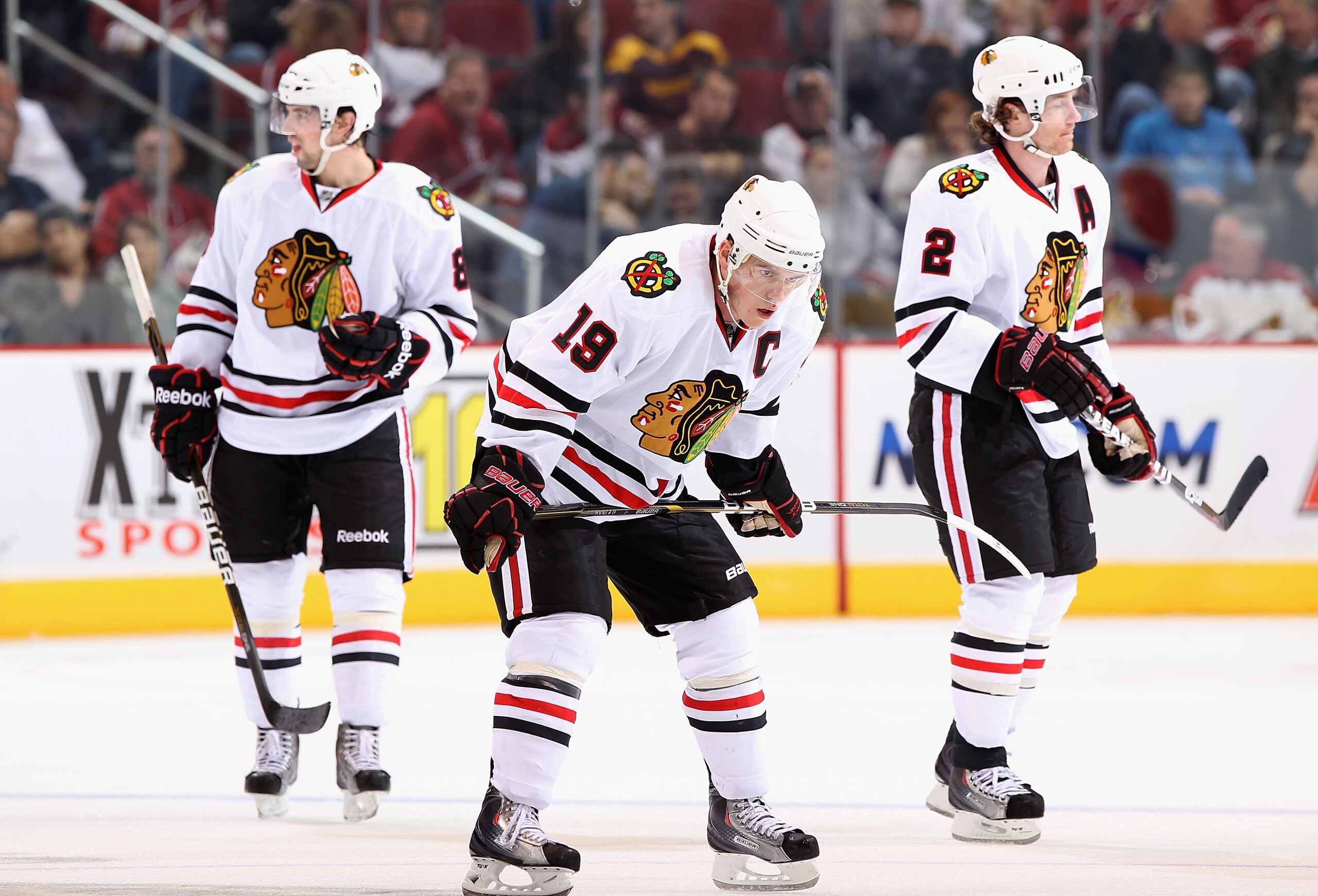 GLENDALE, AZ - FEBRUARY 12:  (L-R) Nick Leddy #8, Jonathan Toews #19 and Duncan Keith #2 of the Chicago Blackhawks skate up to a face off during the NHL game against the Phoenix Coyotes at Jobing.com Arena on February 12, 2011 in Glendale, Arizona.  The C