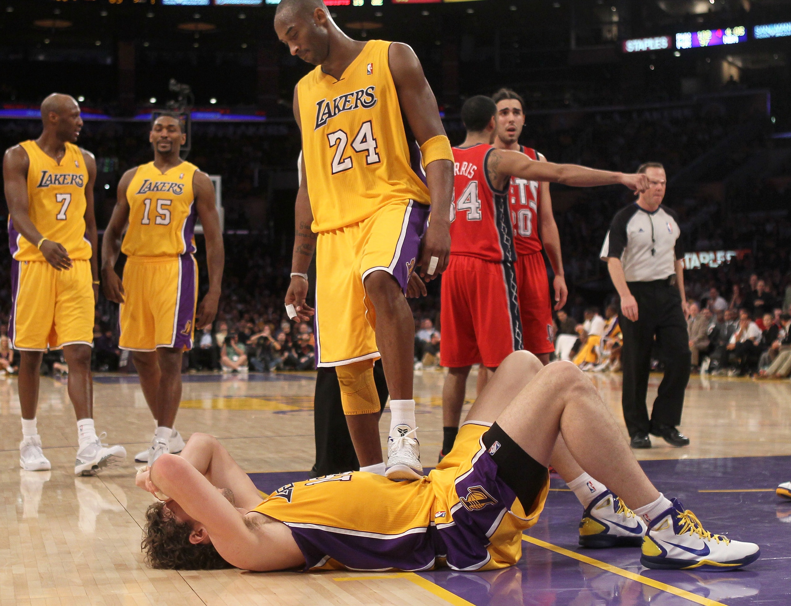 LOS ANGELES, CA - JANUARY 14: Kobe Bryant #24 of the Los Angeles Lakers checks on fallen teammate Pau Gasol #16 in the game against the New Jersey Nets at Staples Center on January 14, 2011 in Los Angeles, California. The Lakers won 100-88.  NOTE TO USER: