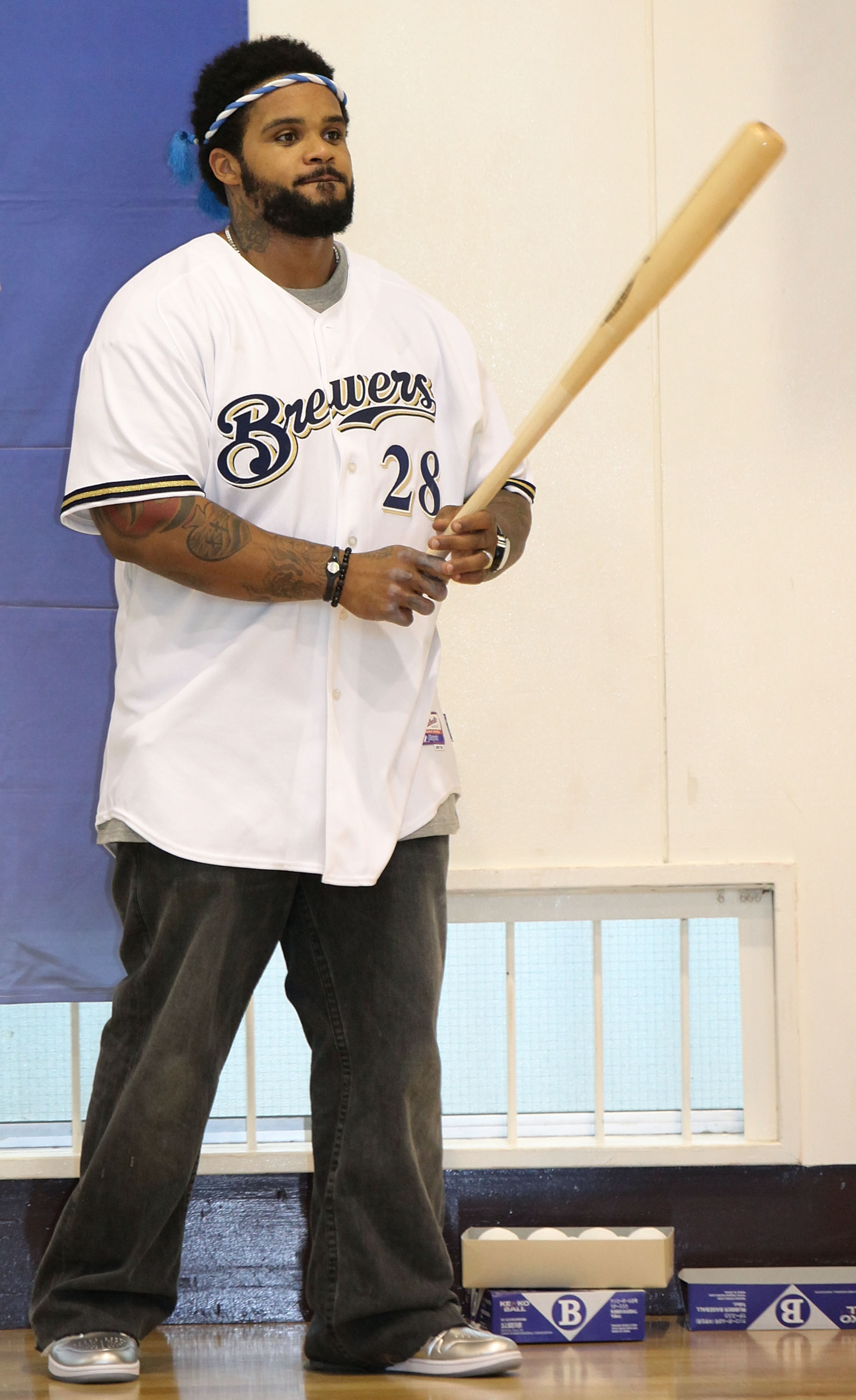 TOKYO - DECEMBER 15:  Prince Fielder of the Milwaukee Brewers coaches members of the baseball club in batting skills while visiting Minamisuna Junior High School as part of the Major League Baseball (MLB) International Ambassador program to promote the ga