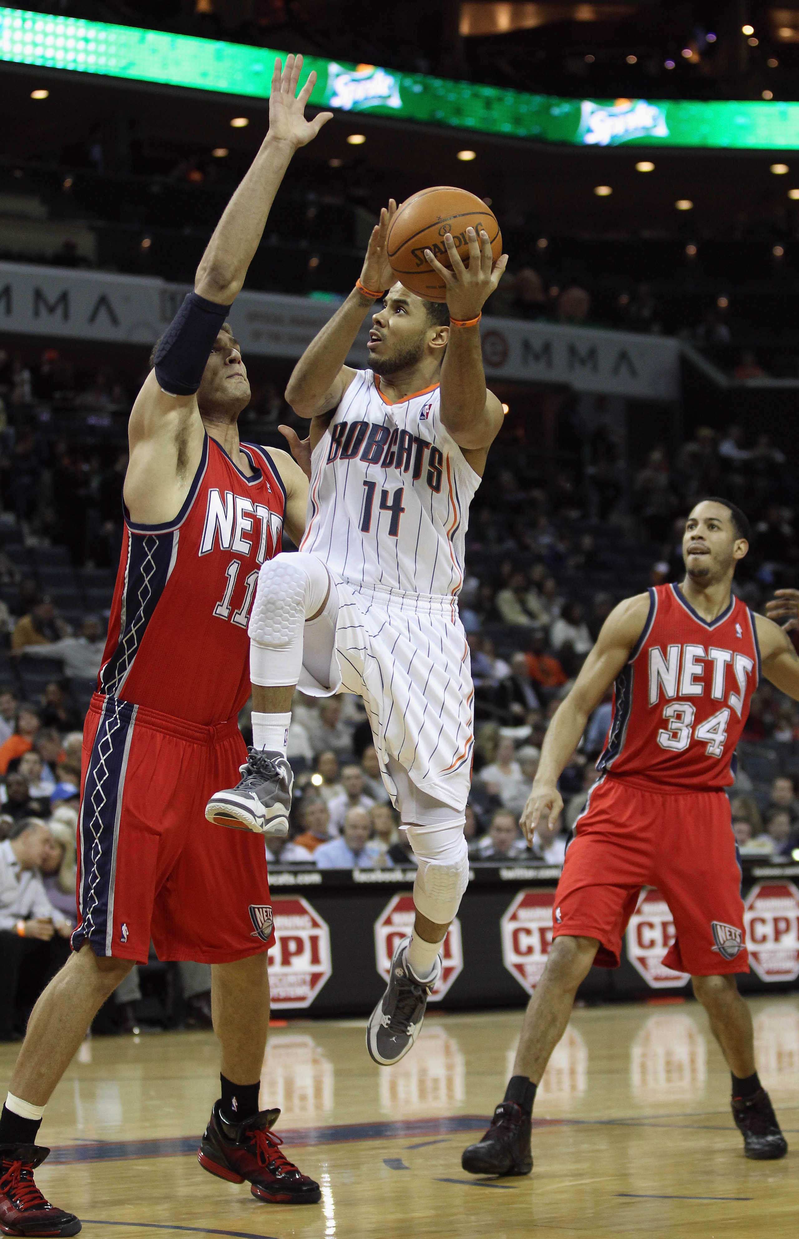 CHARLOTTE, NC - FEBRUARY 11:  Brook Lopez #11 of the New Jersey Nets tries to stop D.J. Augustin #14 of the Charlotte Bobcats during their game at Time Warner Cable Arena on February 11, 2011 in Charlotte, North Carolina. NOTE TO USER: User expressly ackn