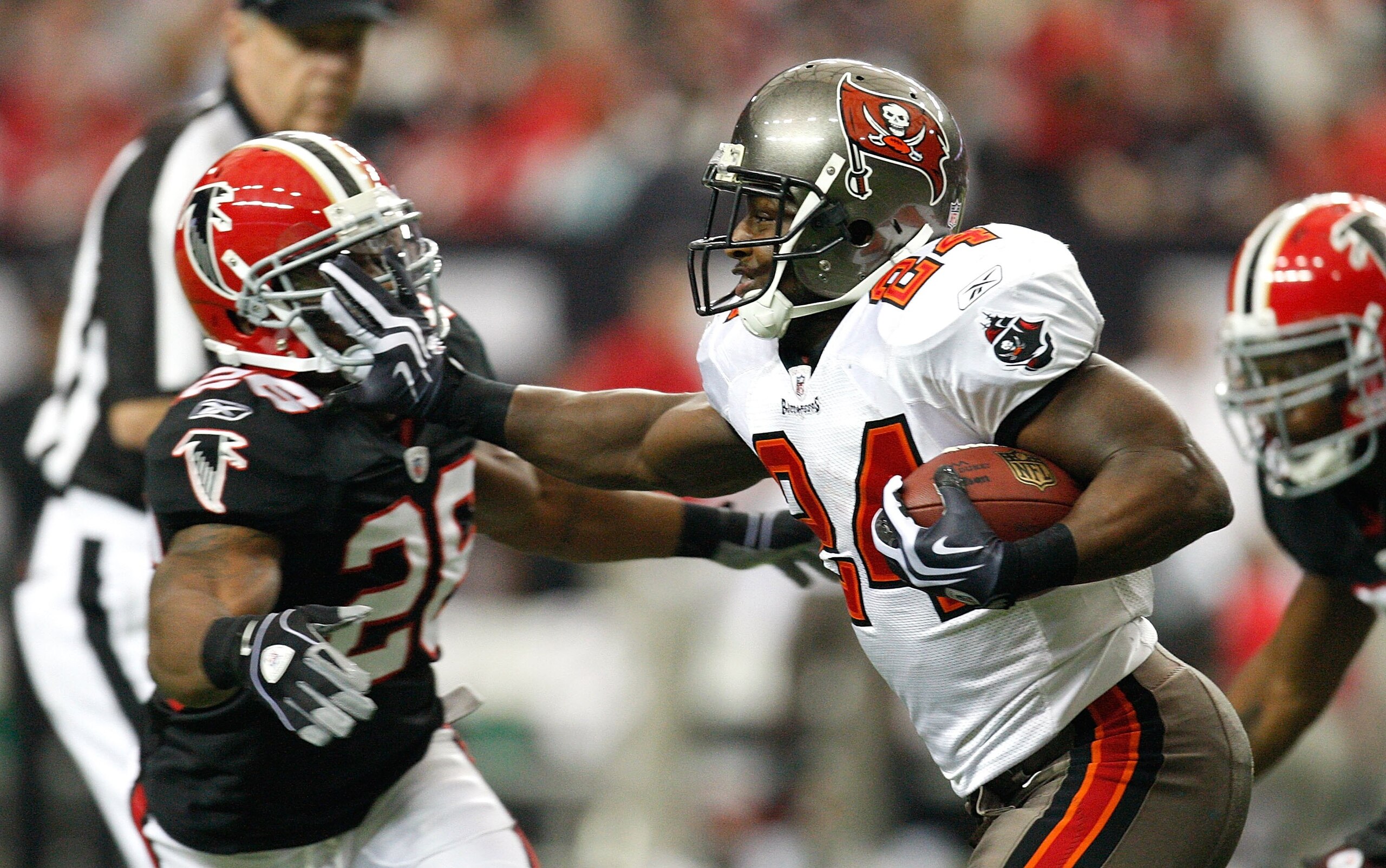ATLANTA - NOVEMBER 29: Cadillac Williams #24 of the Tampa Bay Buccaneers stiff arms Erik Coleman #26 of the Atlanta Falcons at Georgia Dome on November 29, 2009 in Atlanta, Georgia. (Photo by Kevin C. Cox/Getty Images) ATLANTA - NOVEMBER 29: Cadillac Williams #24 of the Tampa Bay Buccaneers stiff arms Erik Coleman #26 of the Atlanta Falcons at Georgia Dome on November 29, 2009 in Atlanta, Georgia. (Photo by Kevin C. Cox/Getty Images)