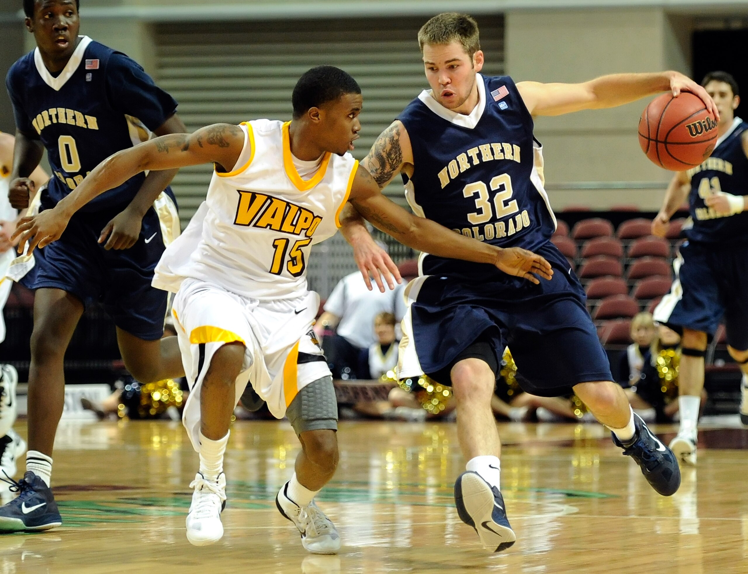LAS VEGAS - NOVEMBER 26:  Devon Beitzel #32 of the Northern Colorado Bears brings the ball up the court against Erik Buggs #15 of the Valparaiso Crusaders during the third round of the Las Vegas Invitational at The Orleans Arena November 26, 2010 in Las V