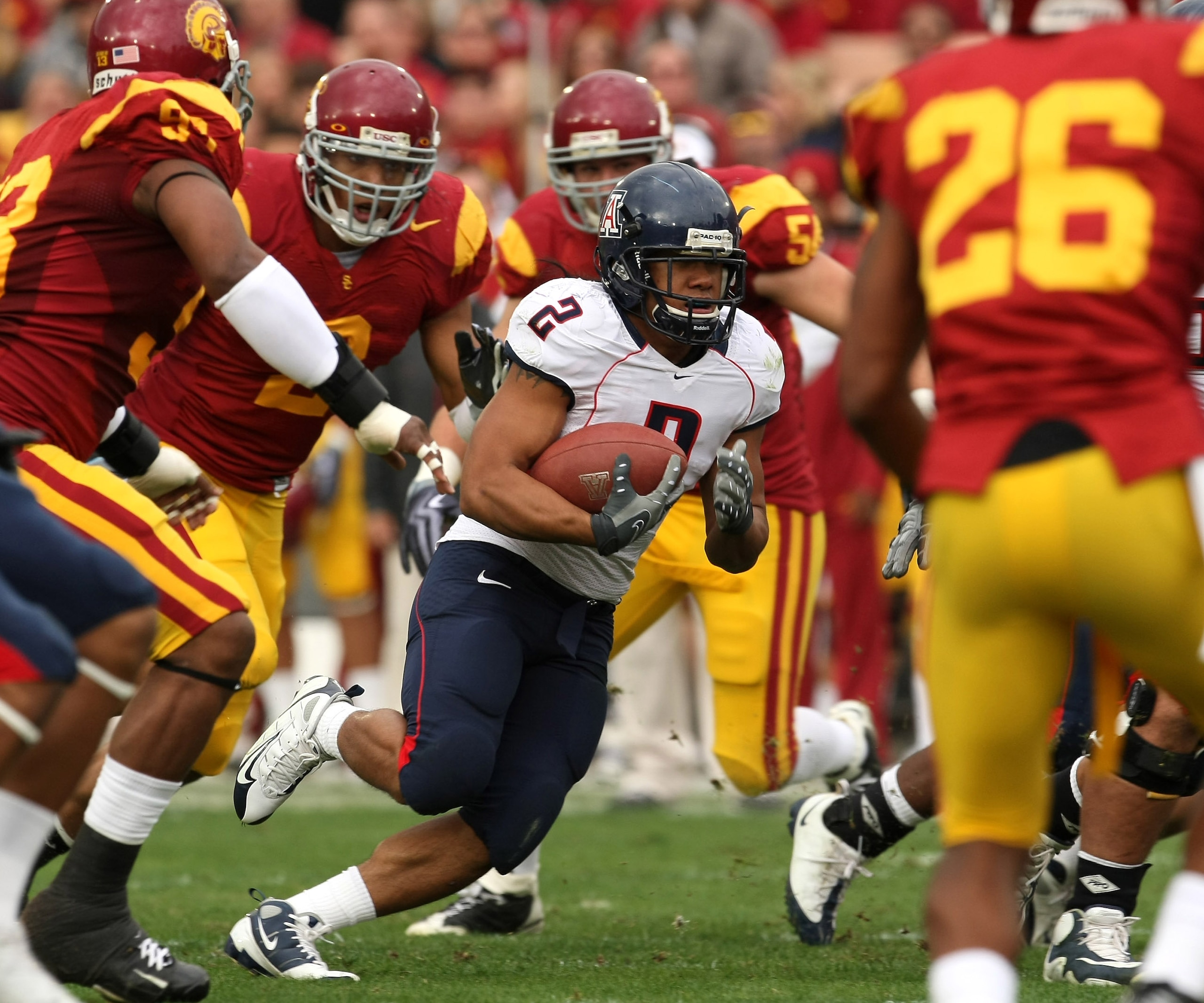 LOS ANGELES, CA - DECEMBER 05:  Running back Keola Antolin #2 of the Arizona Wildcats carries the ball against the USC Trojans on December 5, 2009 at the Los Angeles Coliseum in Los Angeles, California.  (Photo by Stephen Dunn/Getty Images)