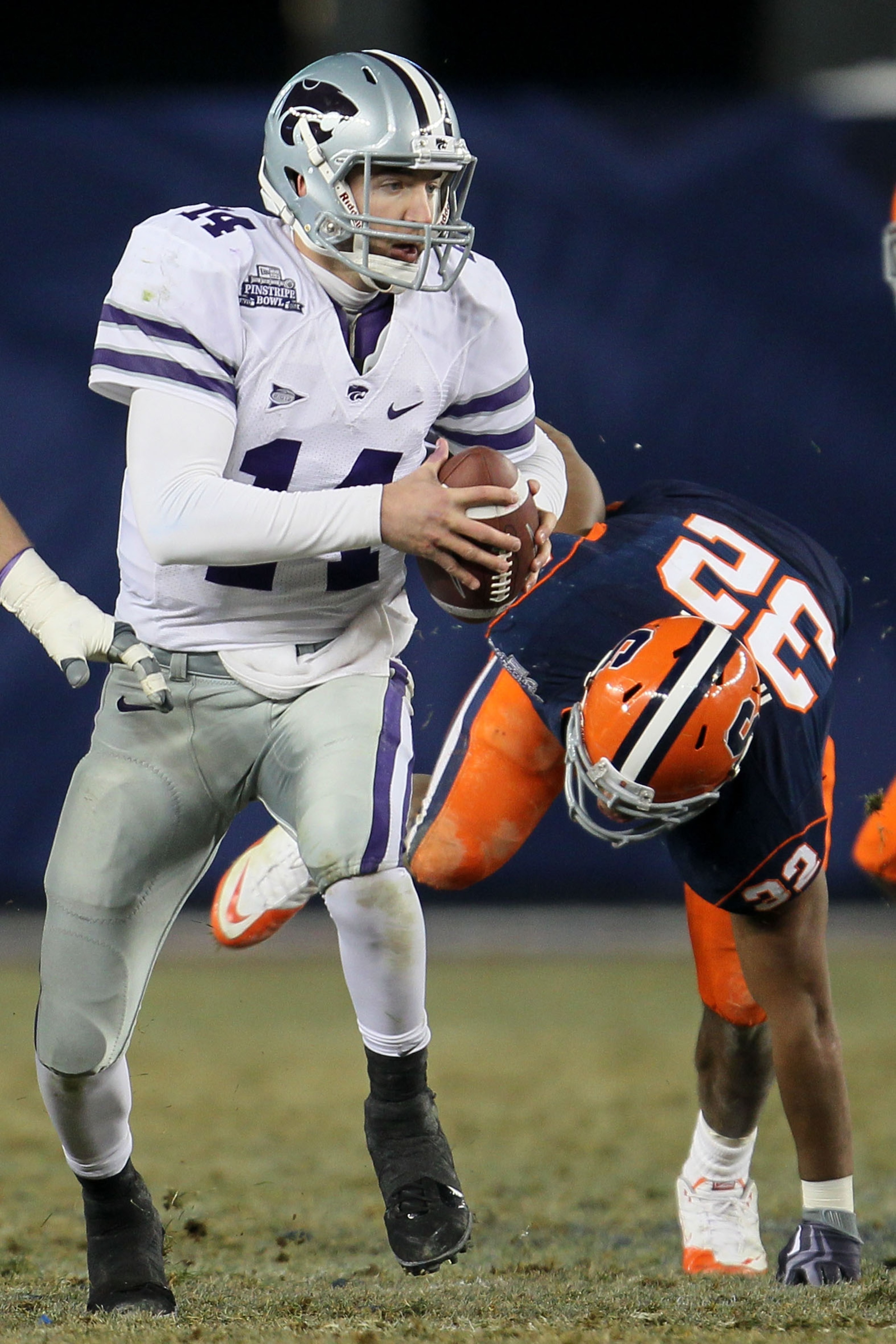 NEW YORK, NY - DECEMBER 30:  Carson Coffman #14 of the Kansas State Wildcats gets out of the tackle of Doug Hogue #32 of the Syracuse Orange during the New Era Pinstripe Bowl at Yankee Stadium on December 30, 2010 in New York, New York.  (Photo by Chris M