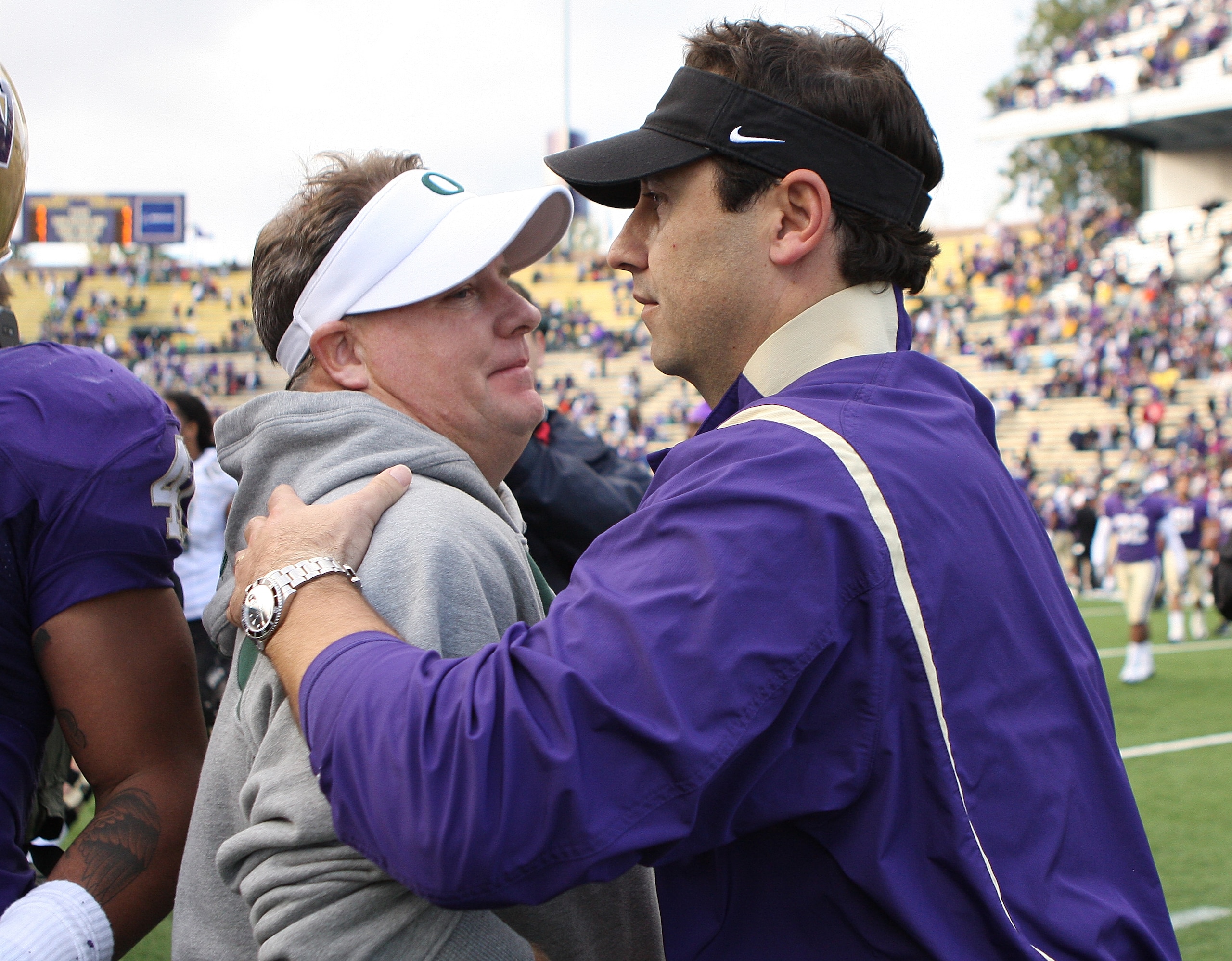 SEATTLE - OCTOBER 24:  Head coach Steve Sarkisian (R) of the Washington Huskies congratulates head coach Chip Kelly of the Oregon Ducks after the game on October 24, 2009 at Husky Stadium in Seattle, Washington. The Ducks defeated the Huskies 43-19. (Phot