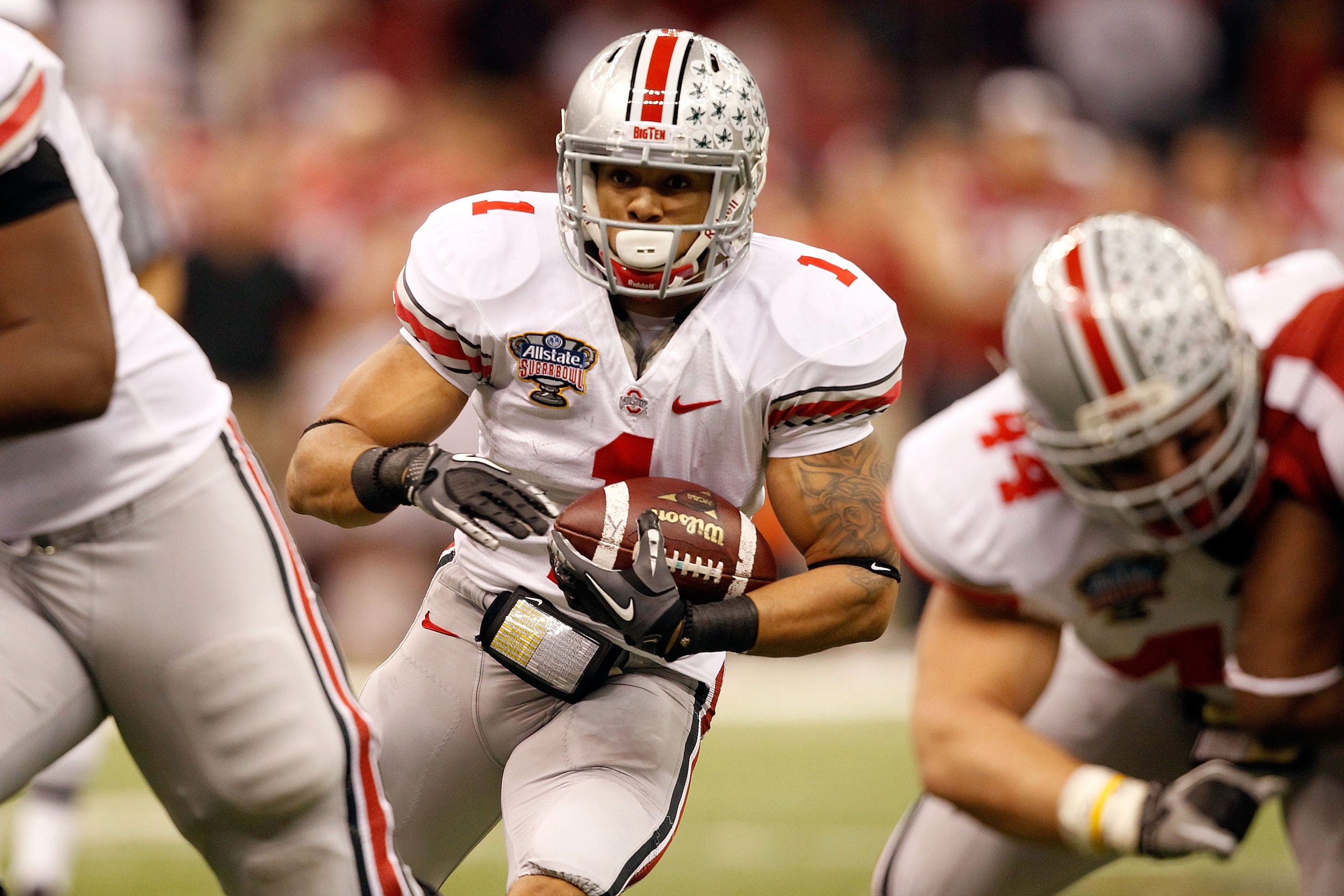 NEW ORLEANS, LA - JANUARY 04:  Dan Herron #1 of the Ohio State Buckeyes runs the ball against the Arkansas Razorbacks during the Allstate Sugar Bowl at the Louisiana Superdome on January 4, 2011 in New Orleans, Louisiana.  (Photo by Matthew Stockman/Getty