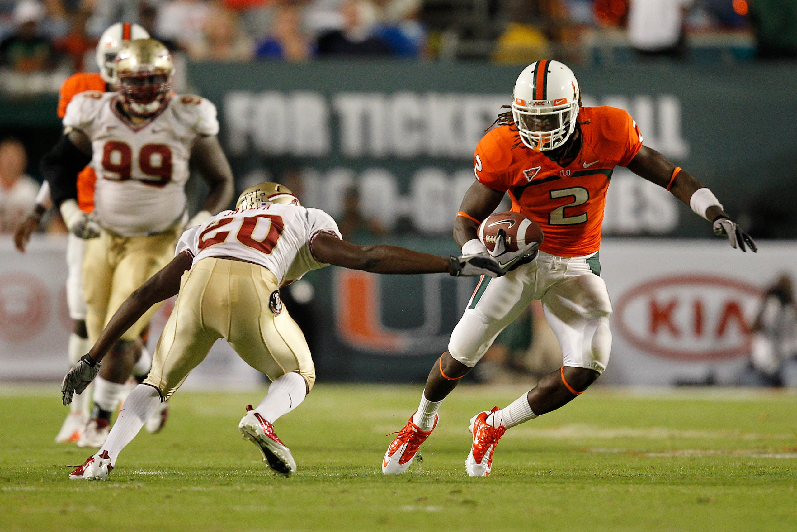 MIAMI, FL - OCTOBER 9: Graig Cooper #2 of the Miami Hurricanes runs with the ball and eludes the tackloe of Lamarcus Joyner #20 of the Florida State Seminoles on October 9, 2010 at Sun Life Stadium in Miami, Florida. (Photo by Joel Auerbach/Getty Images)