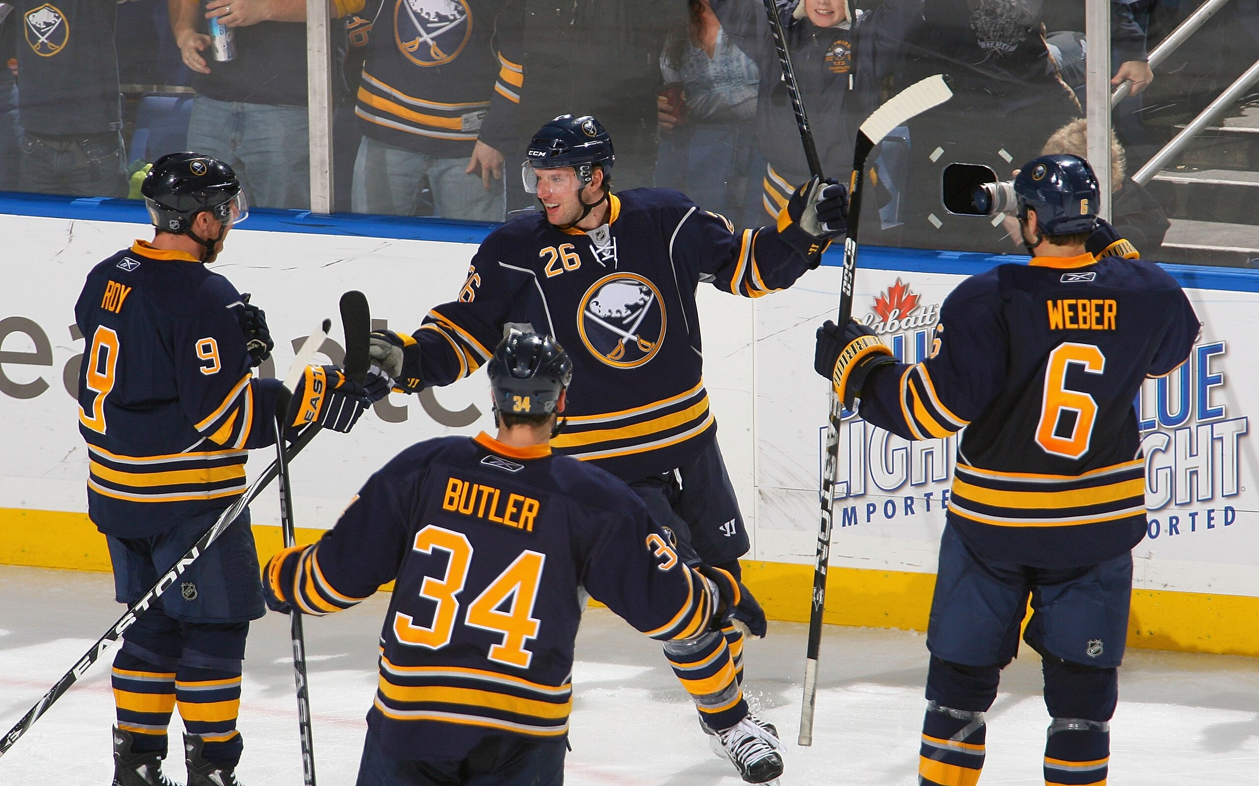 BUFFALO, NY - DECEMBER 09: Derek Roy #9,Chris Butler #34, Thomas Vanek #26 and Mike Weber #6  of the Buffalo Sabres celebrate Vanek's goal in the second period against the San Jose Sharks at HSBC Arena on December 9, 2010 in Buffalo, New York.  (Photo by