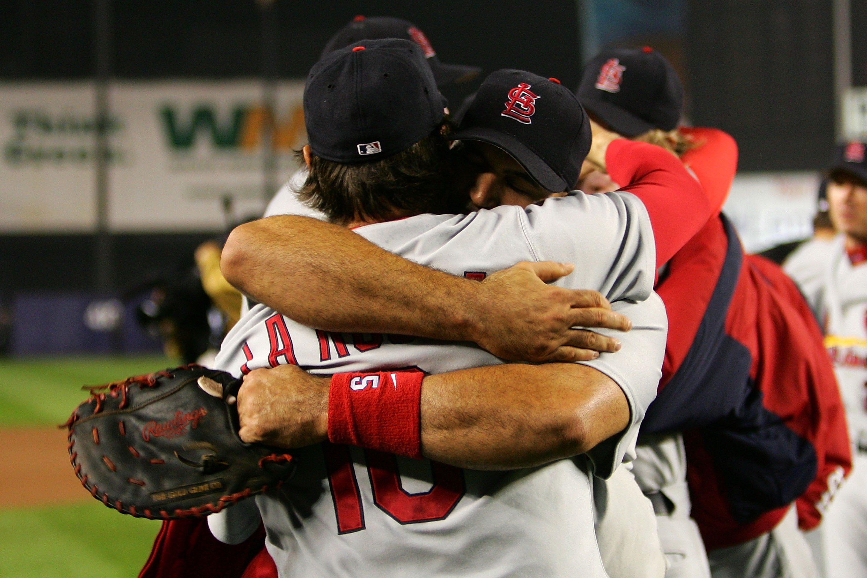NEW YORK - OCTOBER 19: Albert Pujols #5 and manager Tony LaRussa #10 of the St. Louis Cardinals embrace after defeating the New York Mets 3 to 1 in game seven of the NLCS at Shea Stadium on October 19, 2006 in the Flushing neighborhood of the Queens borou