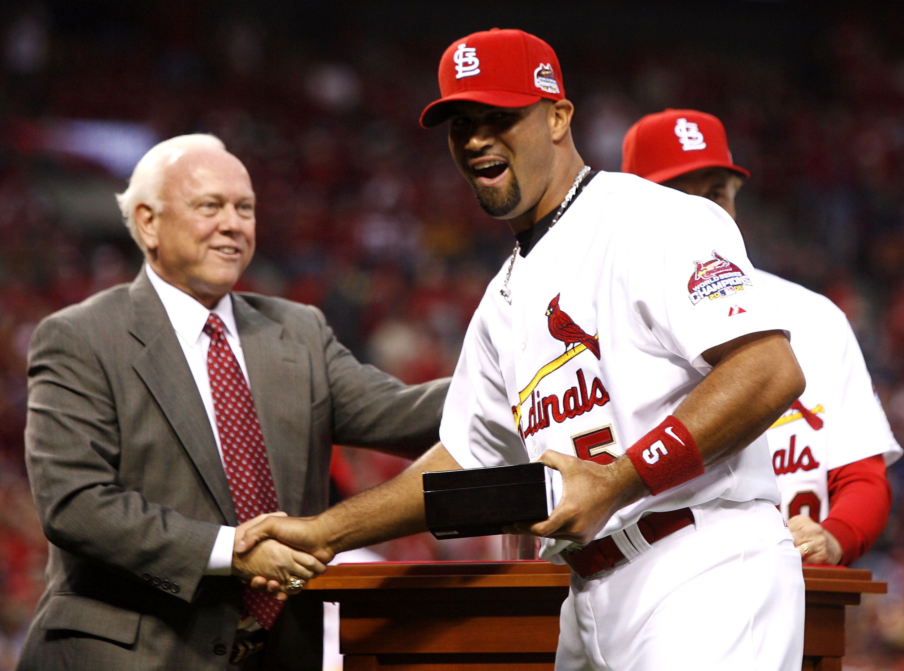 ST. LOUIS, MO - APRIL 3:  General Manager Walt Jocketty presents Albert Pujols #5 of the St. Louis Cardinals with his 2006 World Series Championship ring before playing the New York Mets at Busch Stadium April 3, 2007 in St. Louis, Missouri.  (Photo by Di
