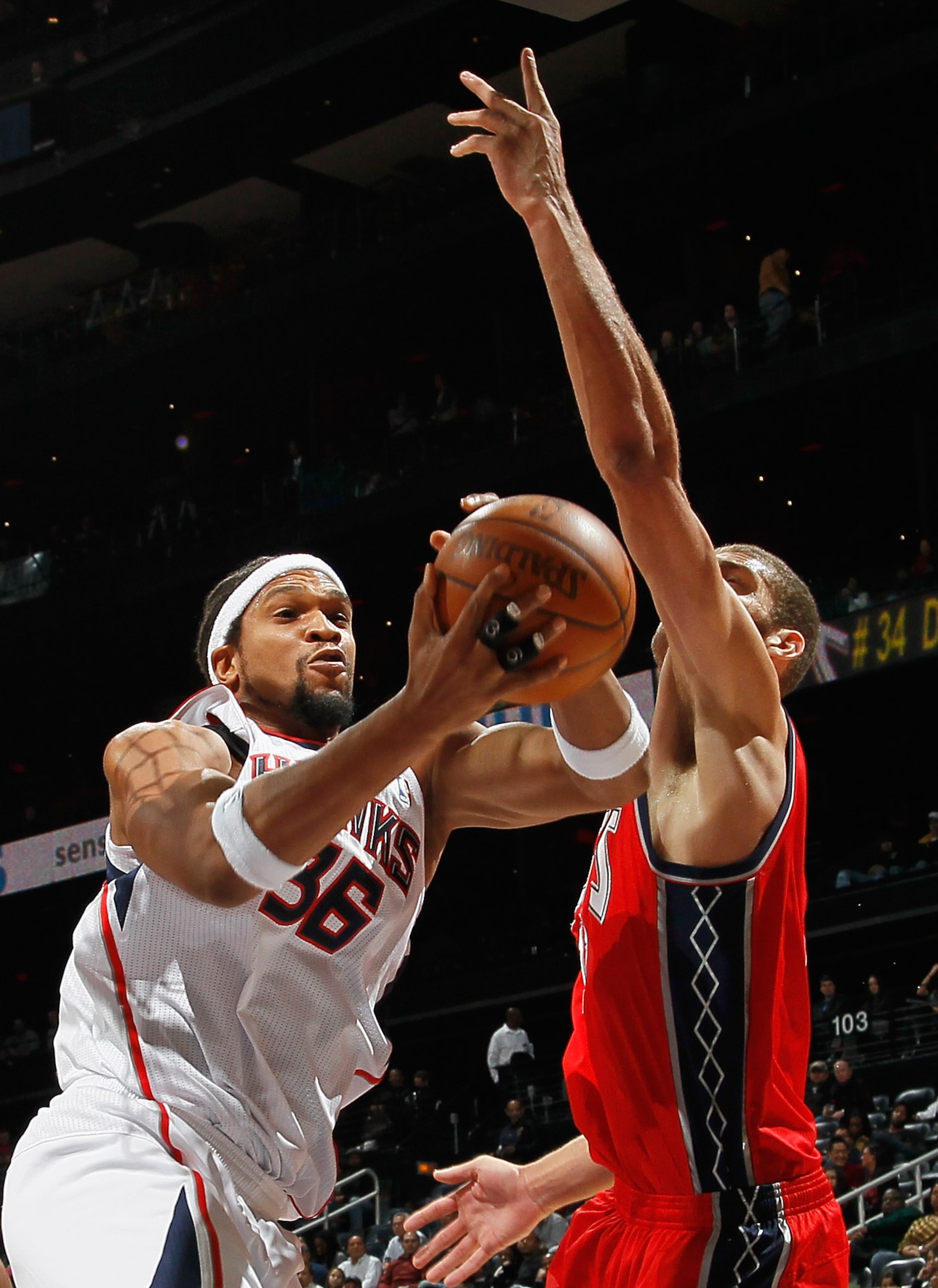 ATLANTA, GA - DECEMBER 07:  Etan Thomas #36 of the Atlanta Hawks grabs a rebound against Brook Lopez #11 of the New Jersey Nets at Philips Arena on December 7, 2010 in Atlanta, Georgia.  NOTE TO USER: User expressly acknowledges and agrees that, by downlo